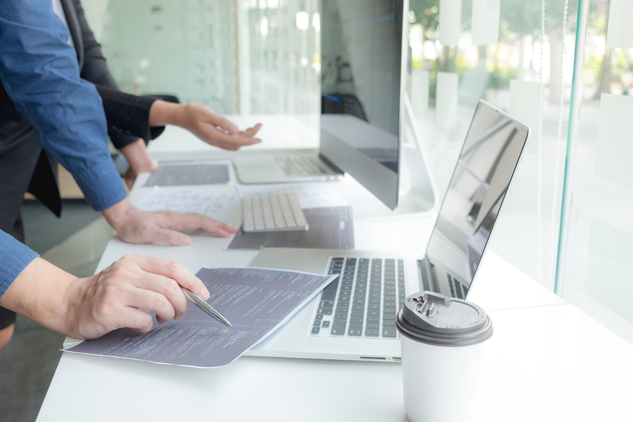 cropped hand of computer programmers brainstorming in office