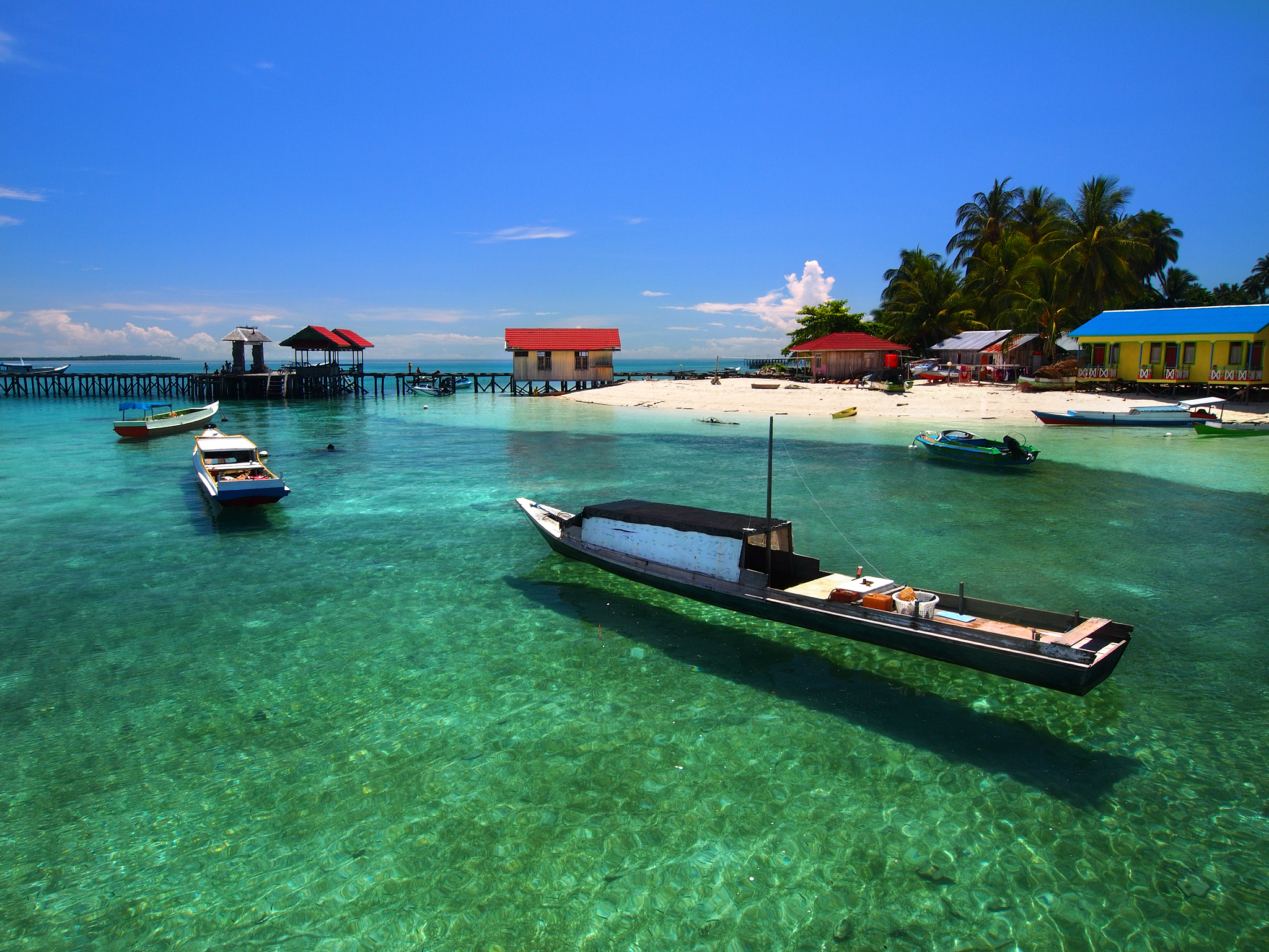 boats moored in sea against sky