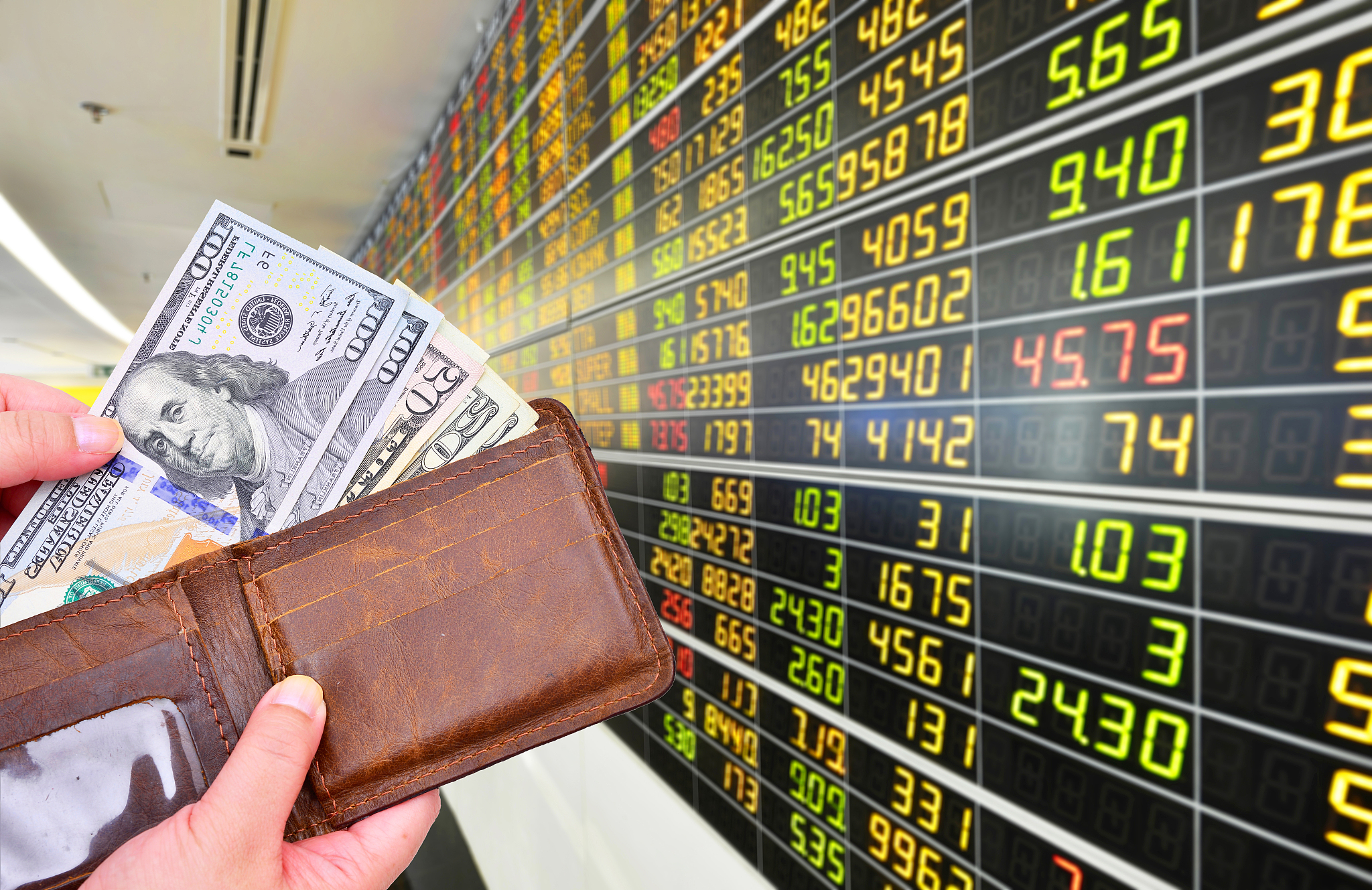dollar banknotes on monitor stock market background.