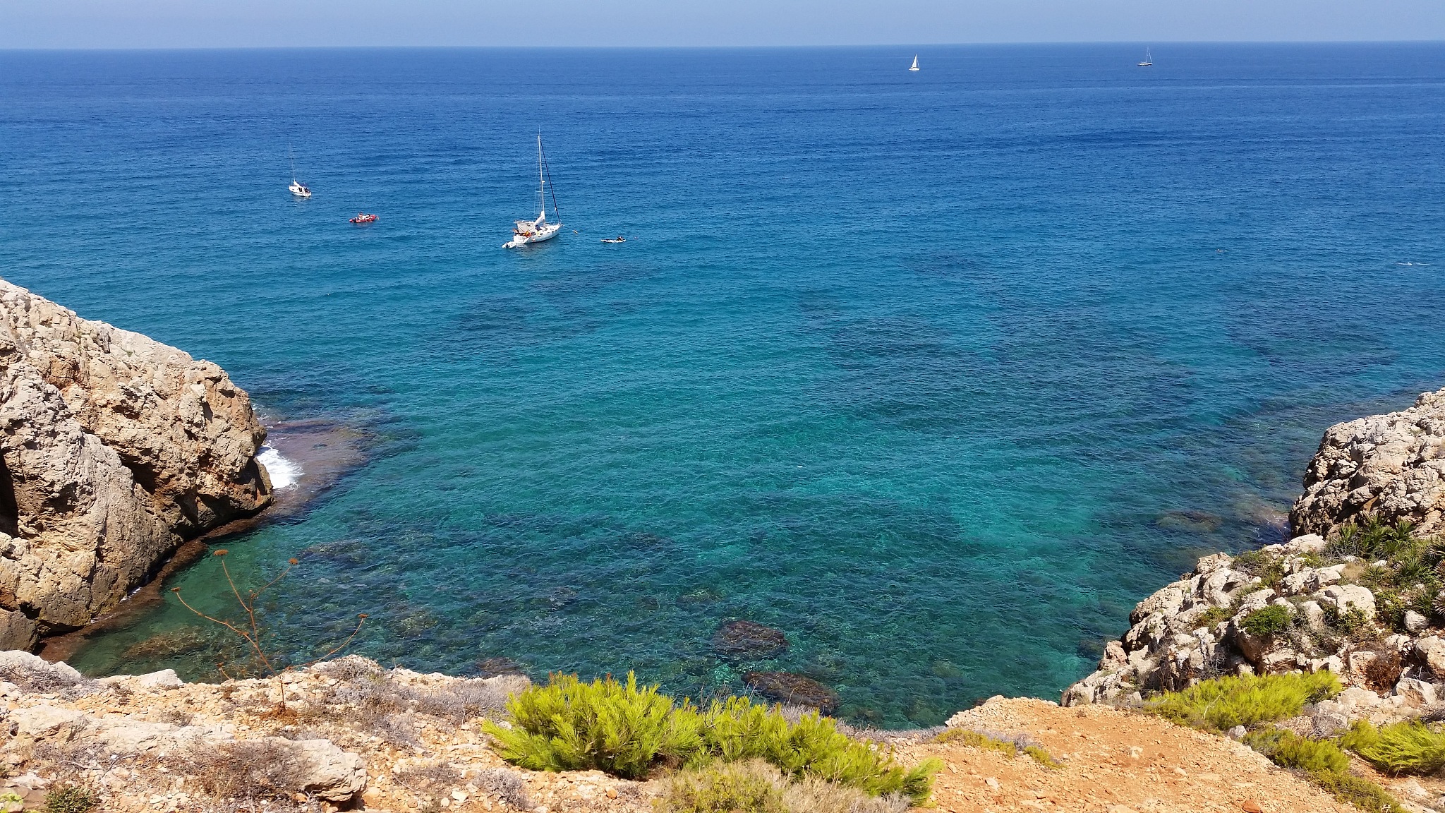 high angle view of rocks by sea against sky
