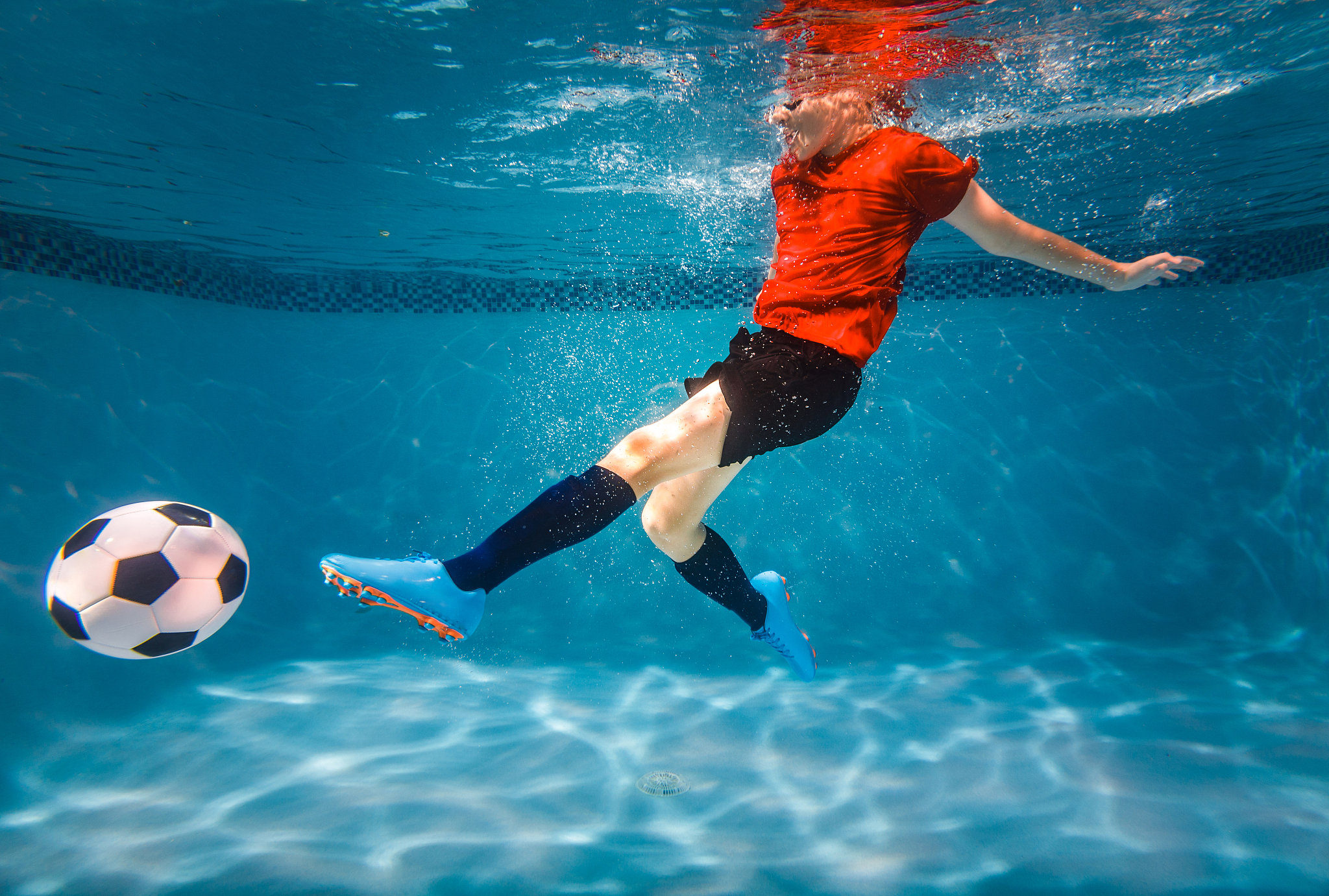 kid underwater soccer