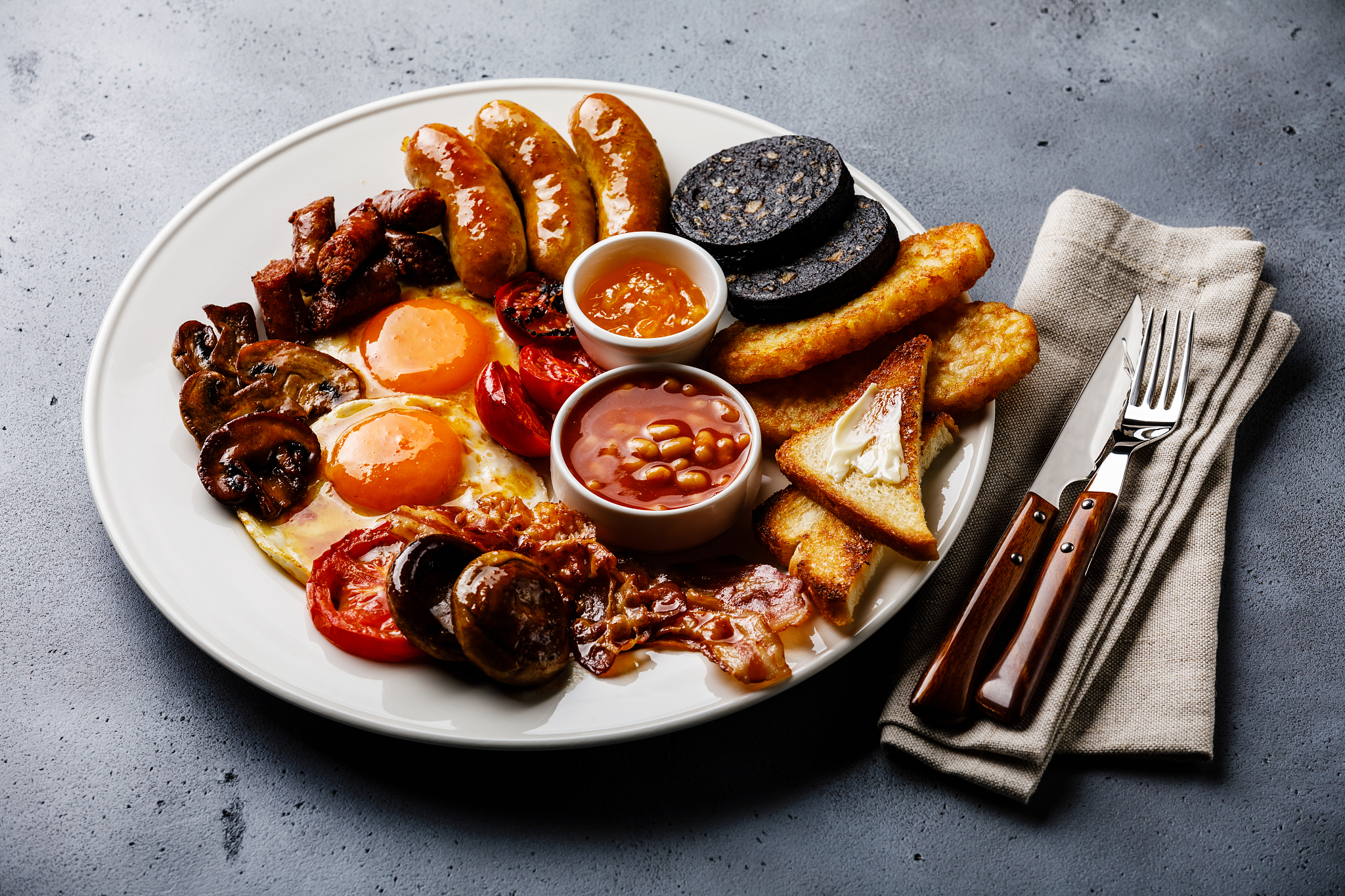full fry up english breakfast with fried eggs, sausages, bacon, 