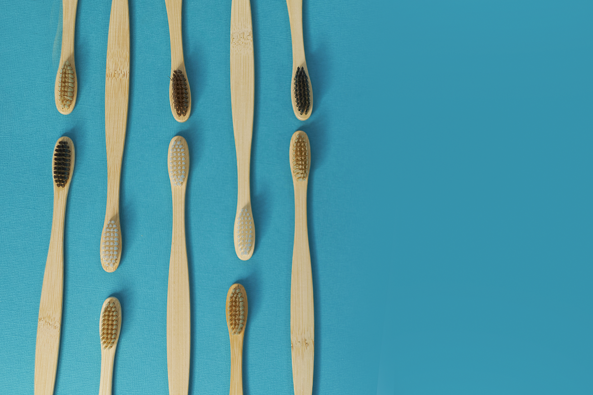 wooden toothbrushes on a blue background. zero waste concept. de