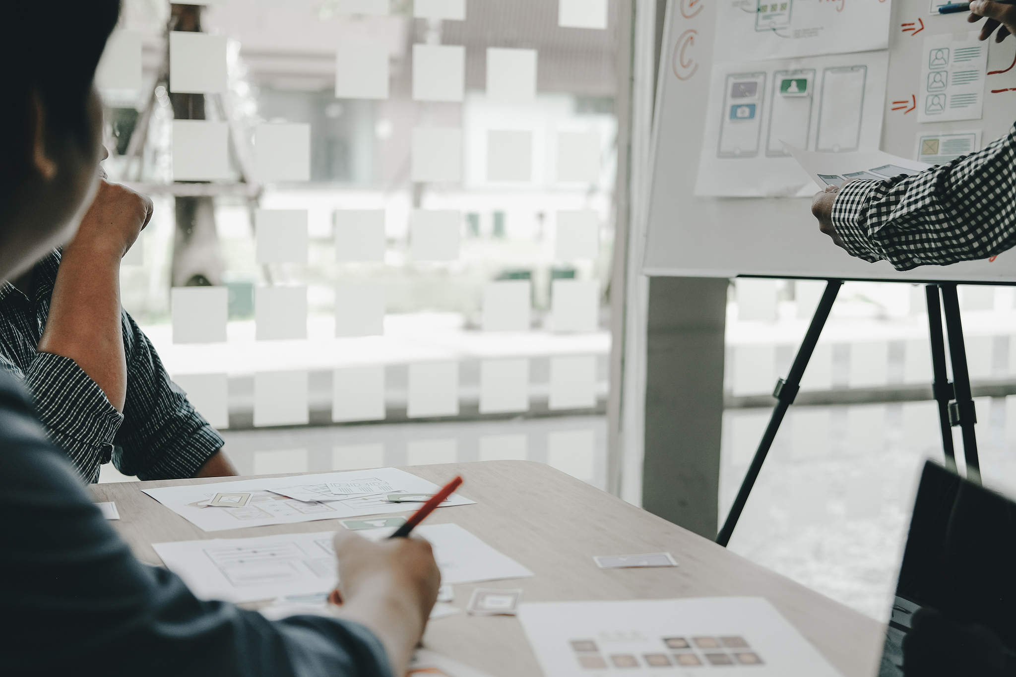midsection of design professionals working on whiteboard