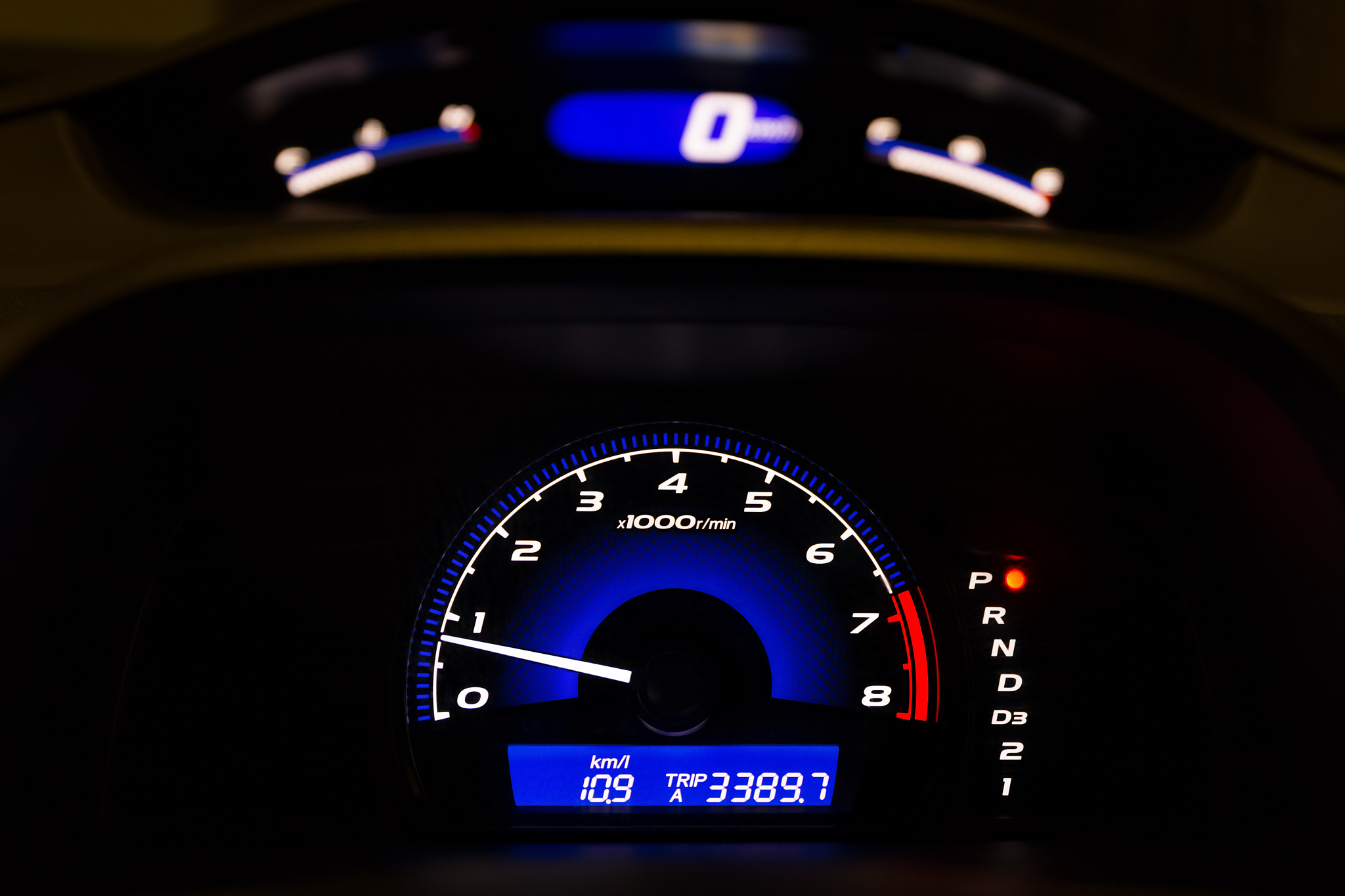 car dashboard with illuminated tachometer and speedometer, hdr.