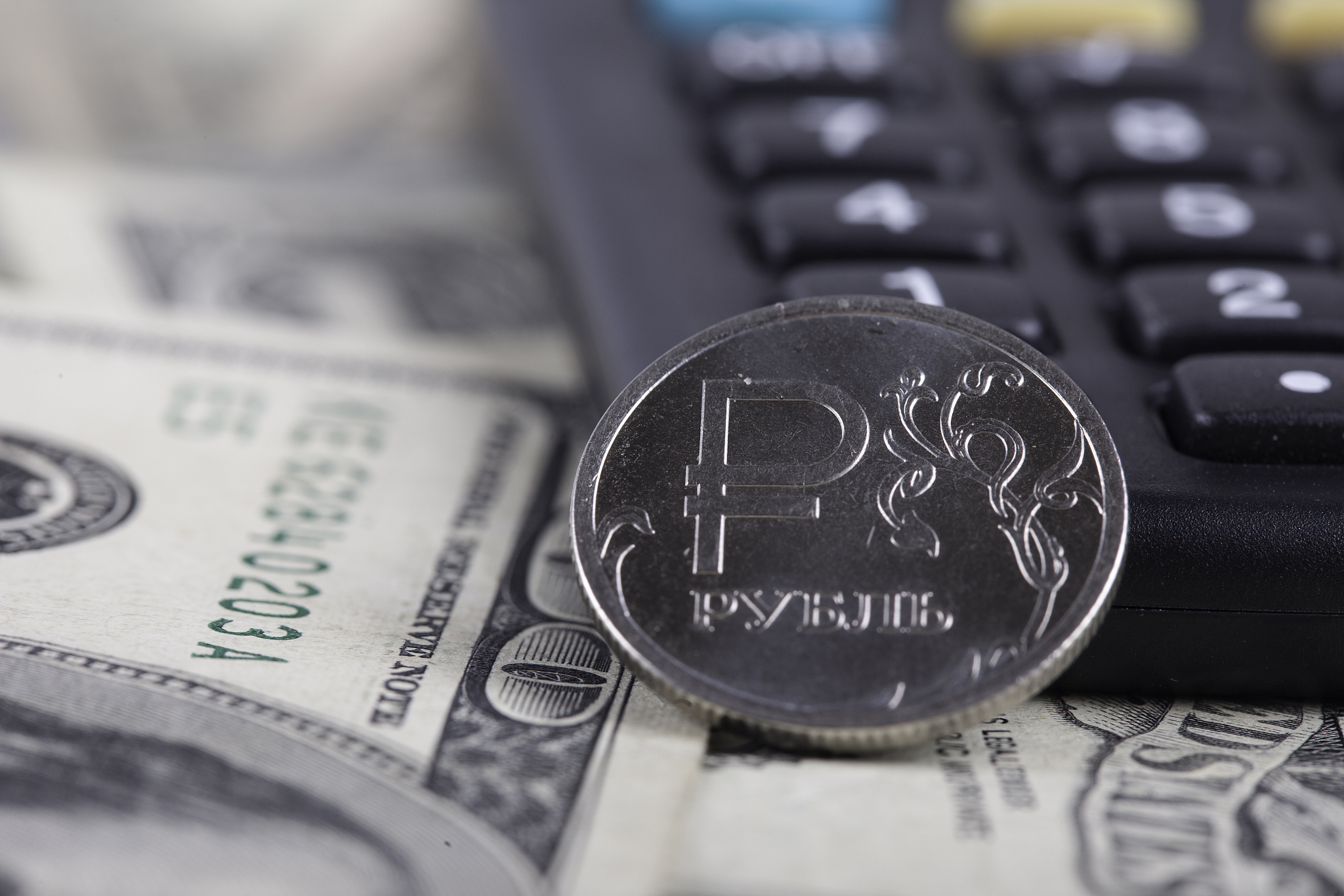 coin ruble closeup, calculator on the background of banknotes do