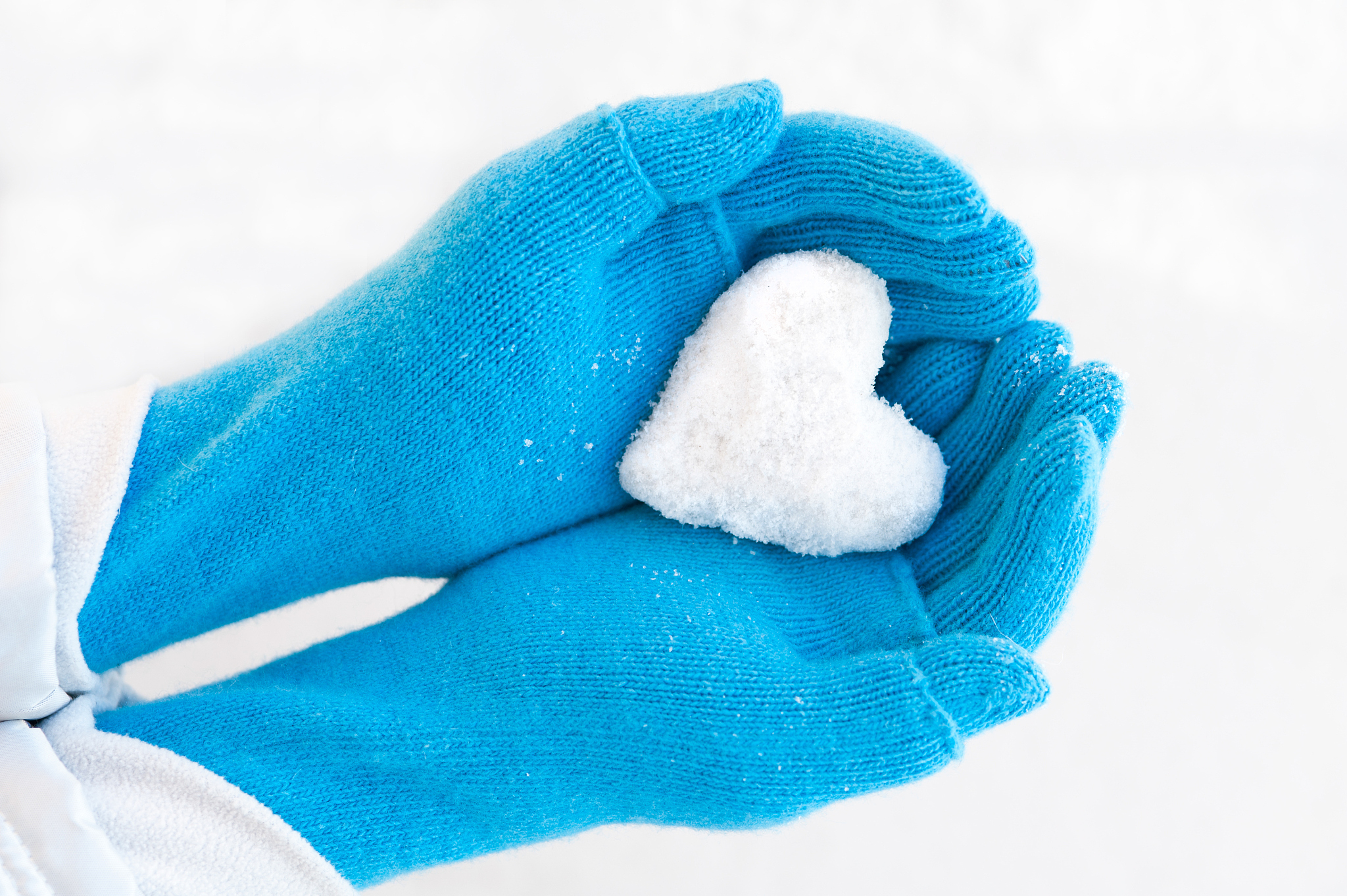 woman's hands holding snowheart.