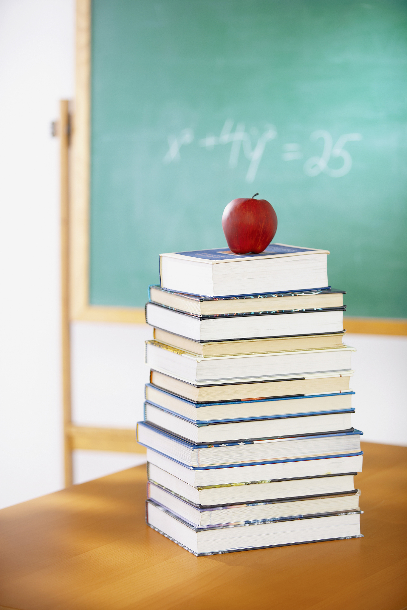 apple on top stack of books