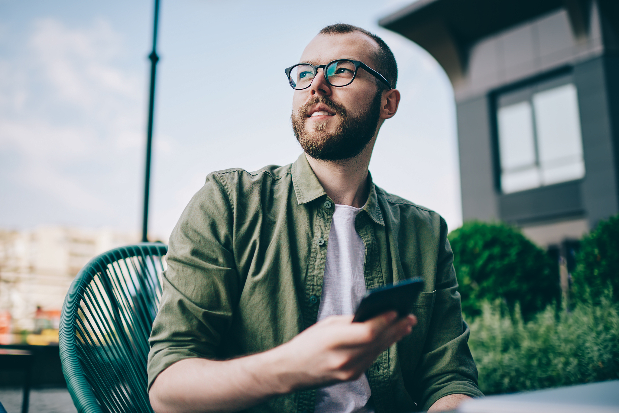 pondering bearded young man looking away while thinking on idea 