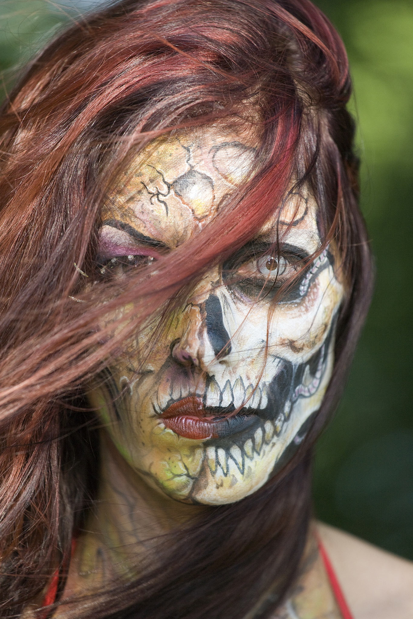 portrait of spooky woman with skull face painting