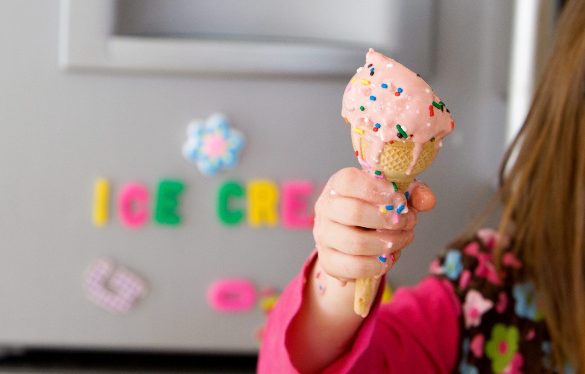 melting icecream cone with sprinkles