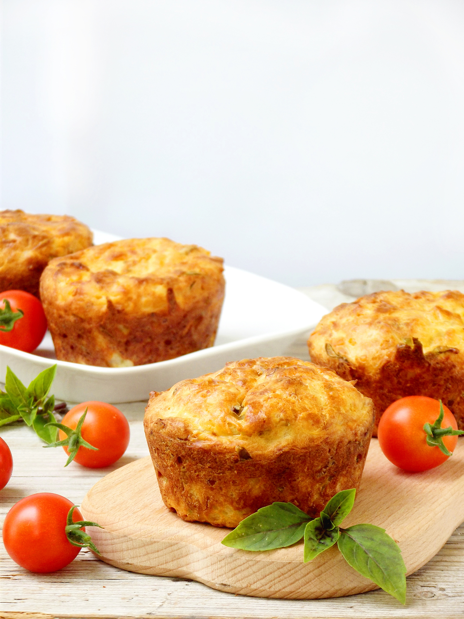 salty snack cakes muffins with cheese, tomatoes and basil