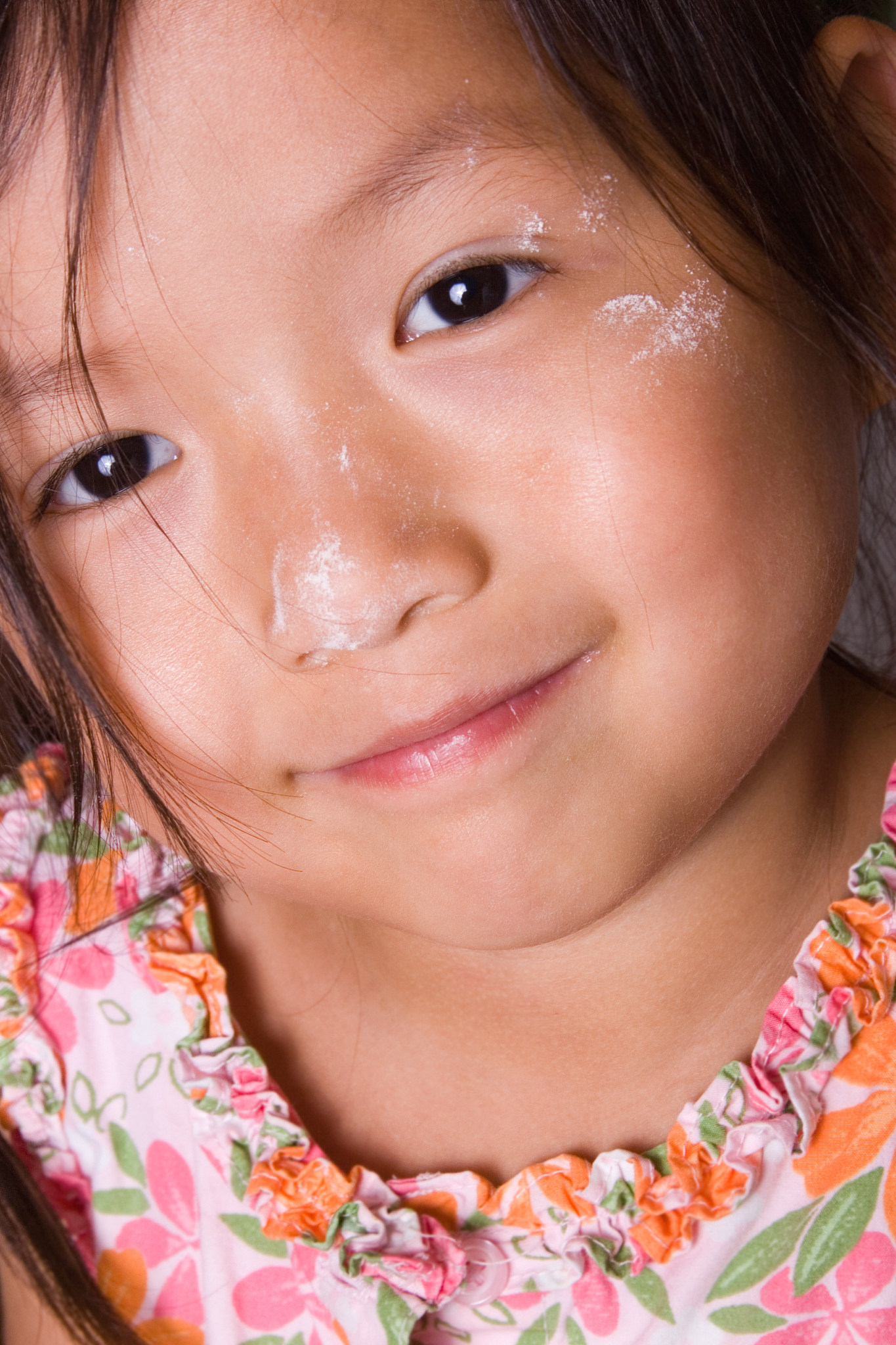 closeup of little girl with flour on her face
