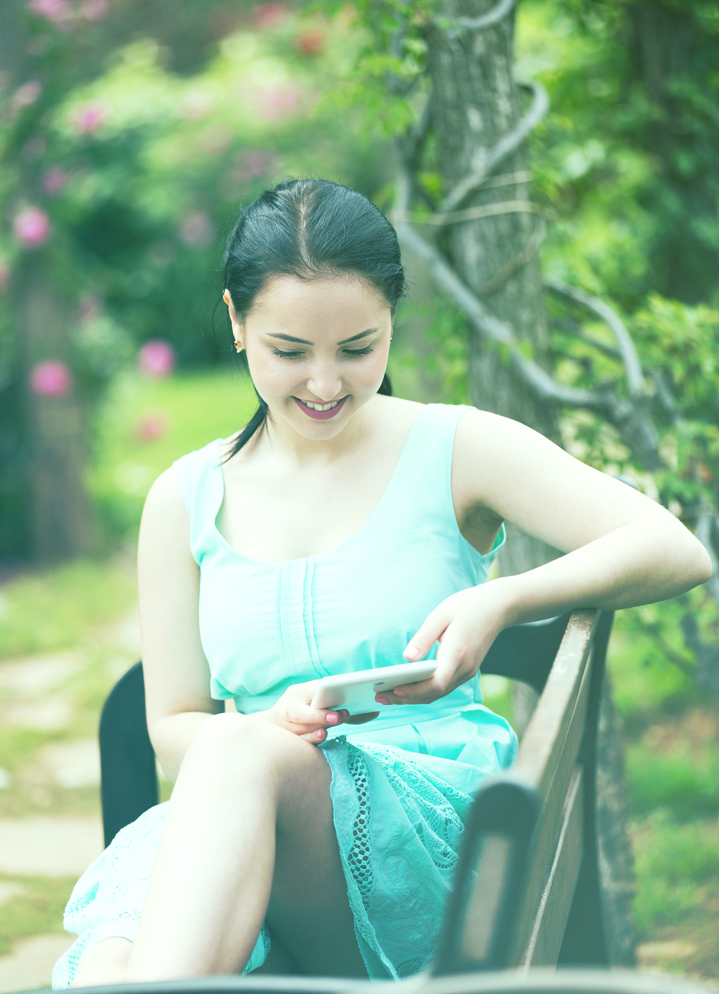 girl sitting on  bench and using digital tablet
