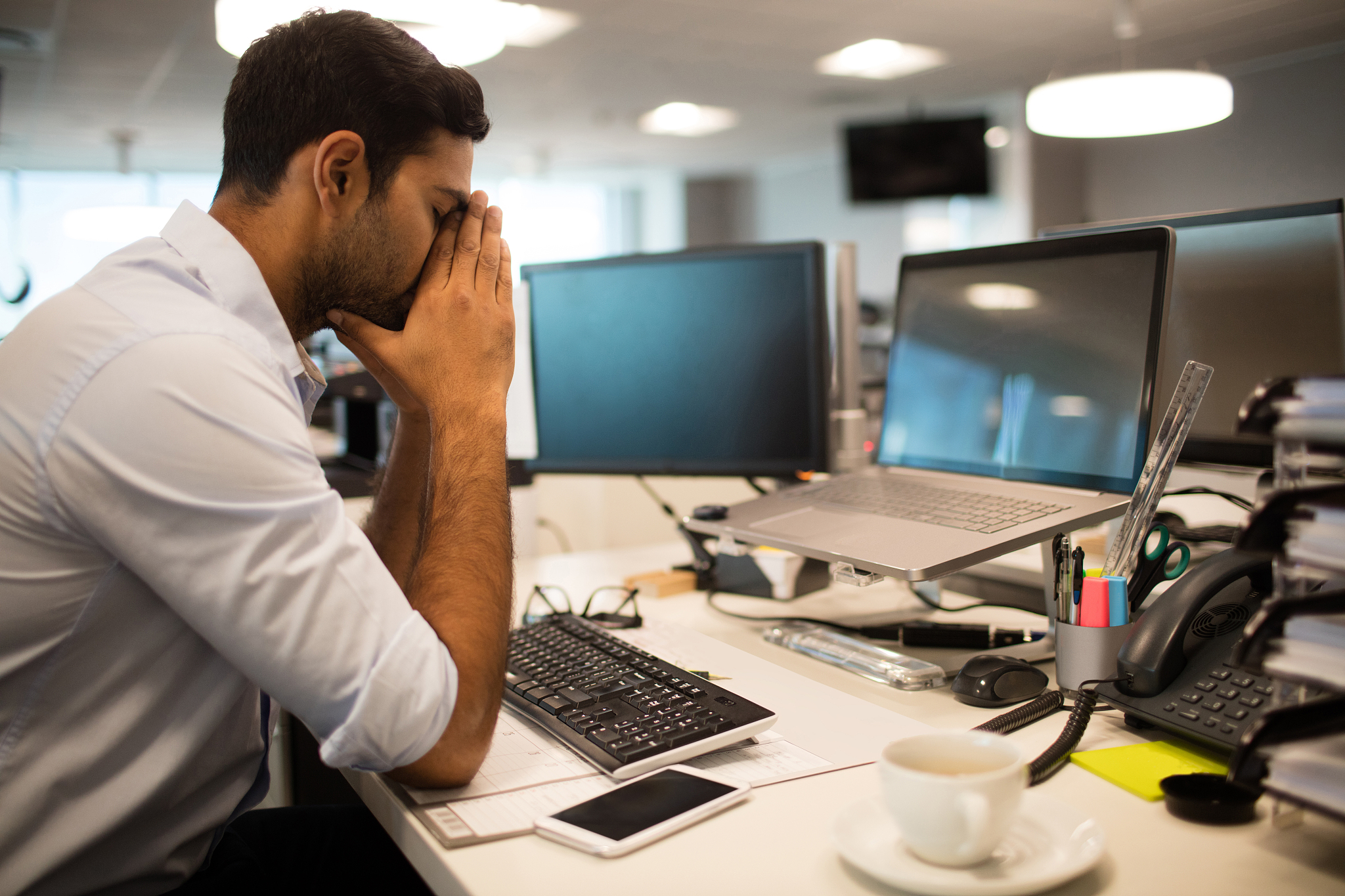 nervous business executive sitting at desk in office