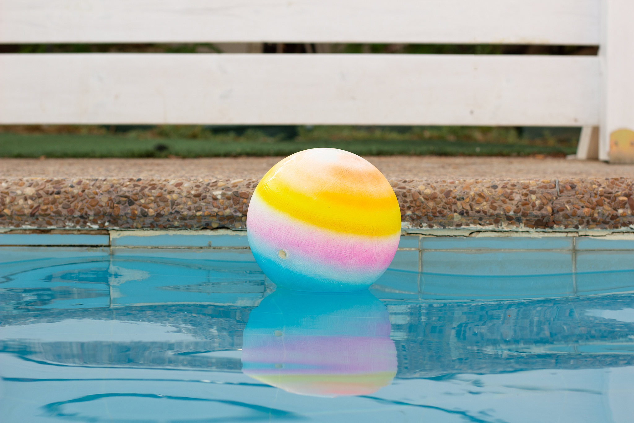ball floating in water surface swimming pool side space outside 