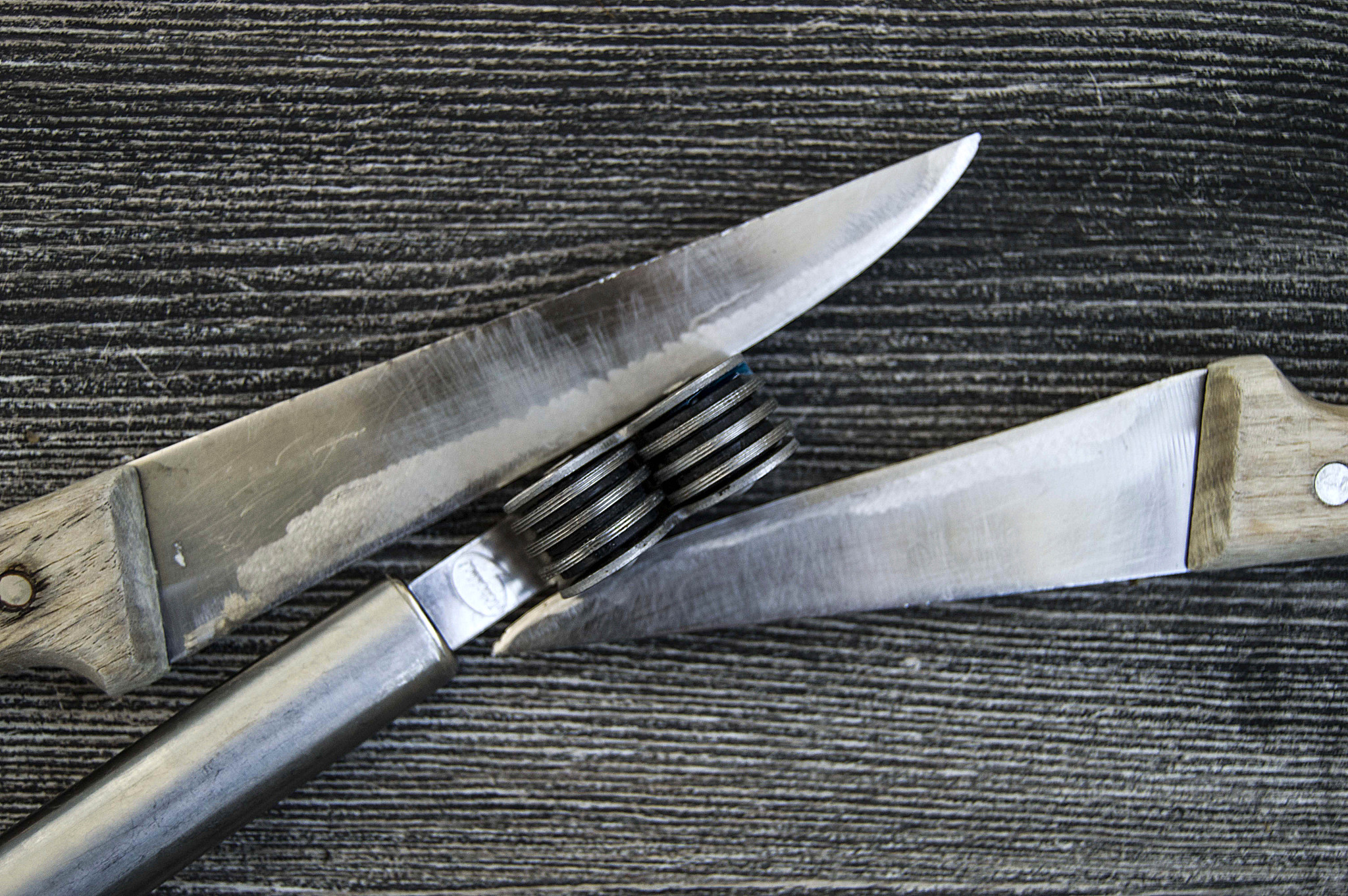 knives stands next to the blade grinding tools, knife sharpening