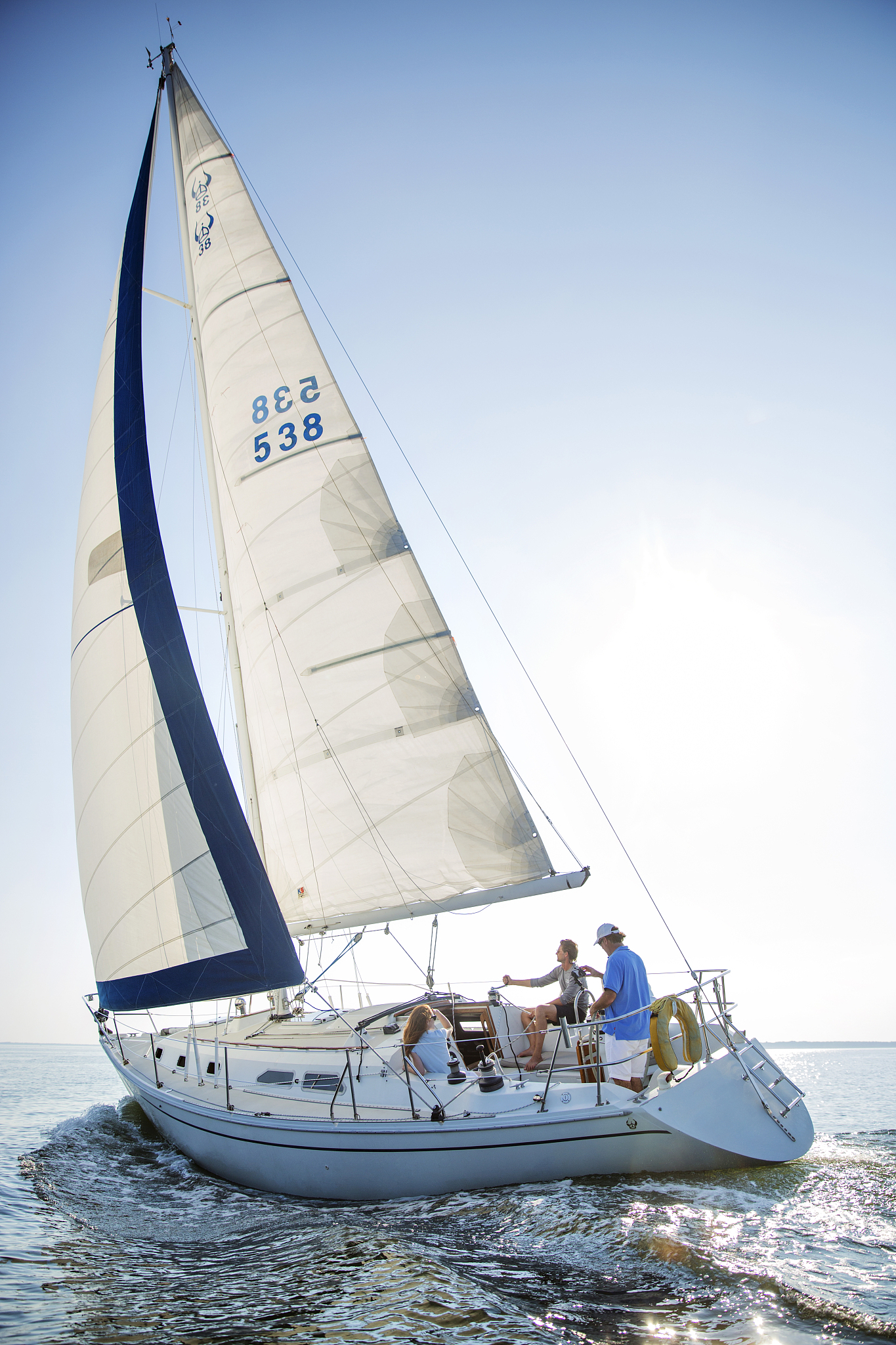 happy friends enjoying drink while traveling in yacht