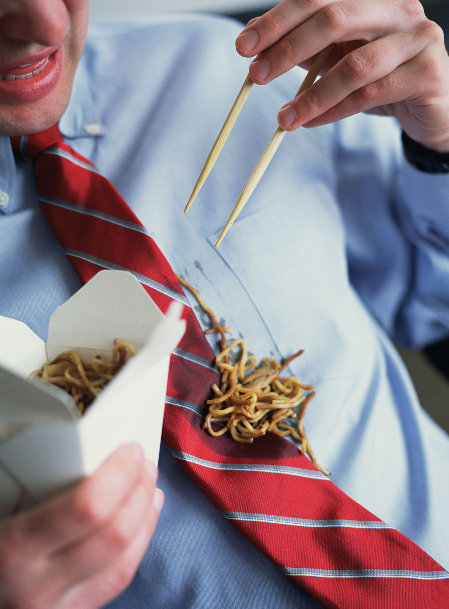 businessman spilling chinese food on necktie