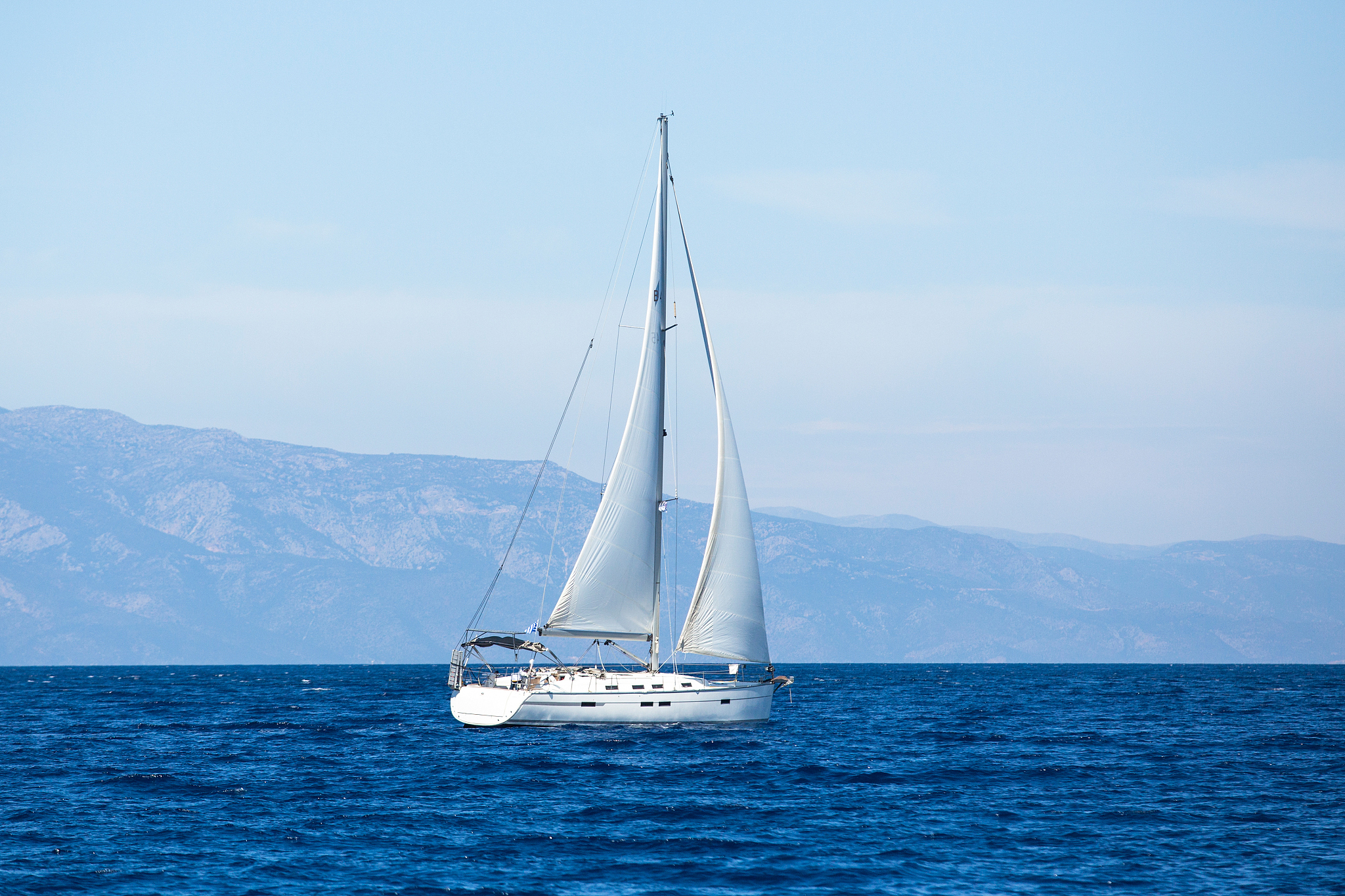 sailing ship yachts with white sails in the sea.