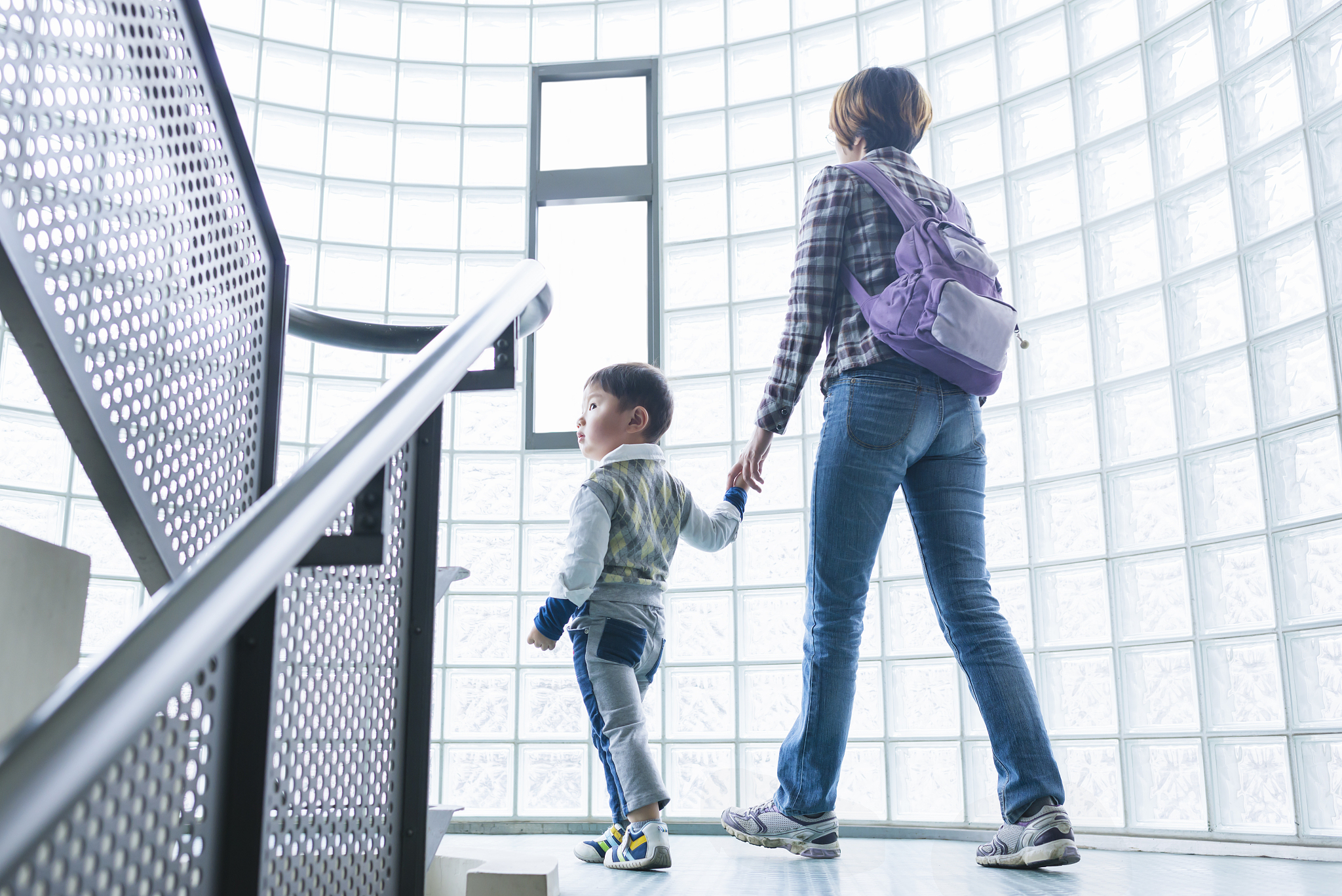 mother and child walking through staires