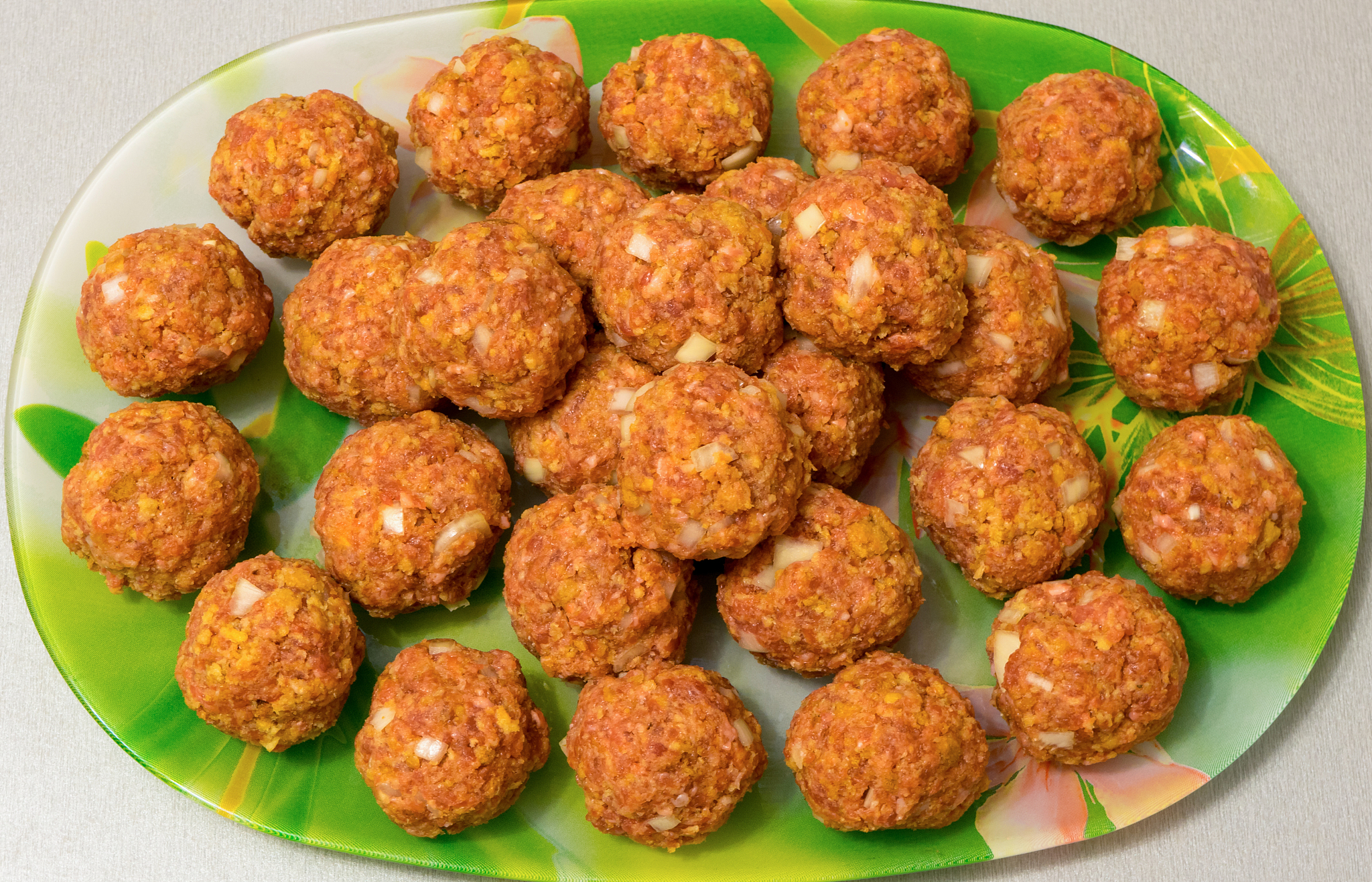 raw meatballs on a platter close up