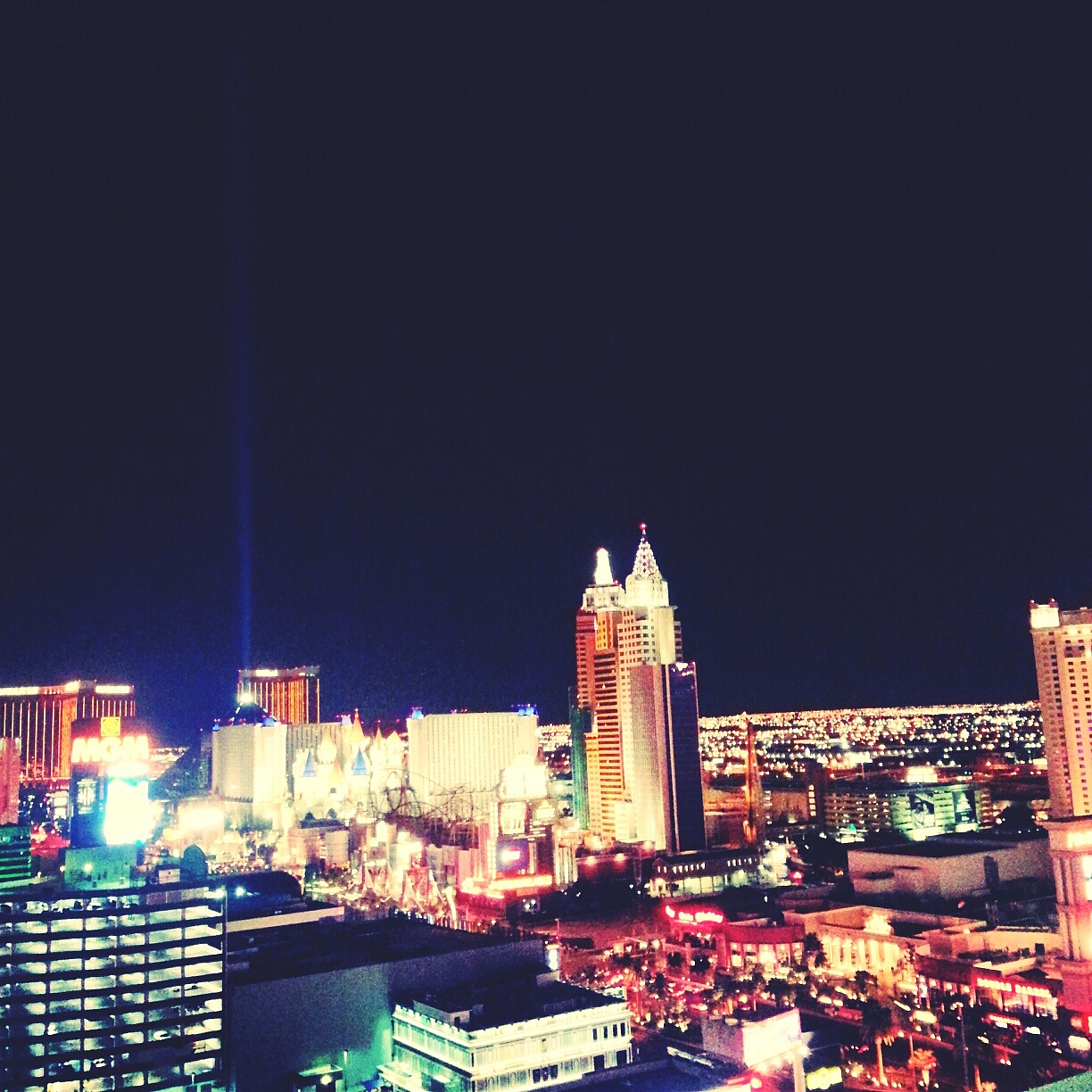 illuminated buildings against clear sky at night