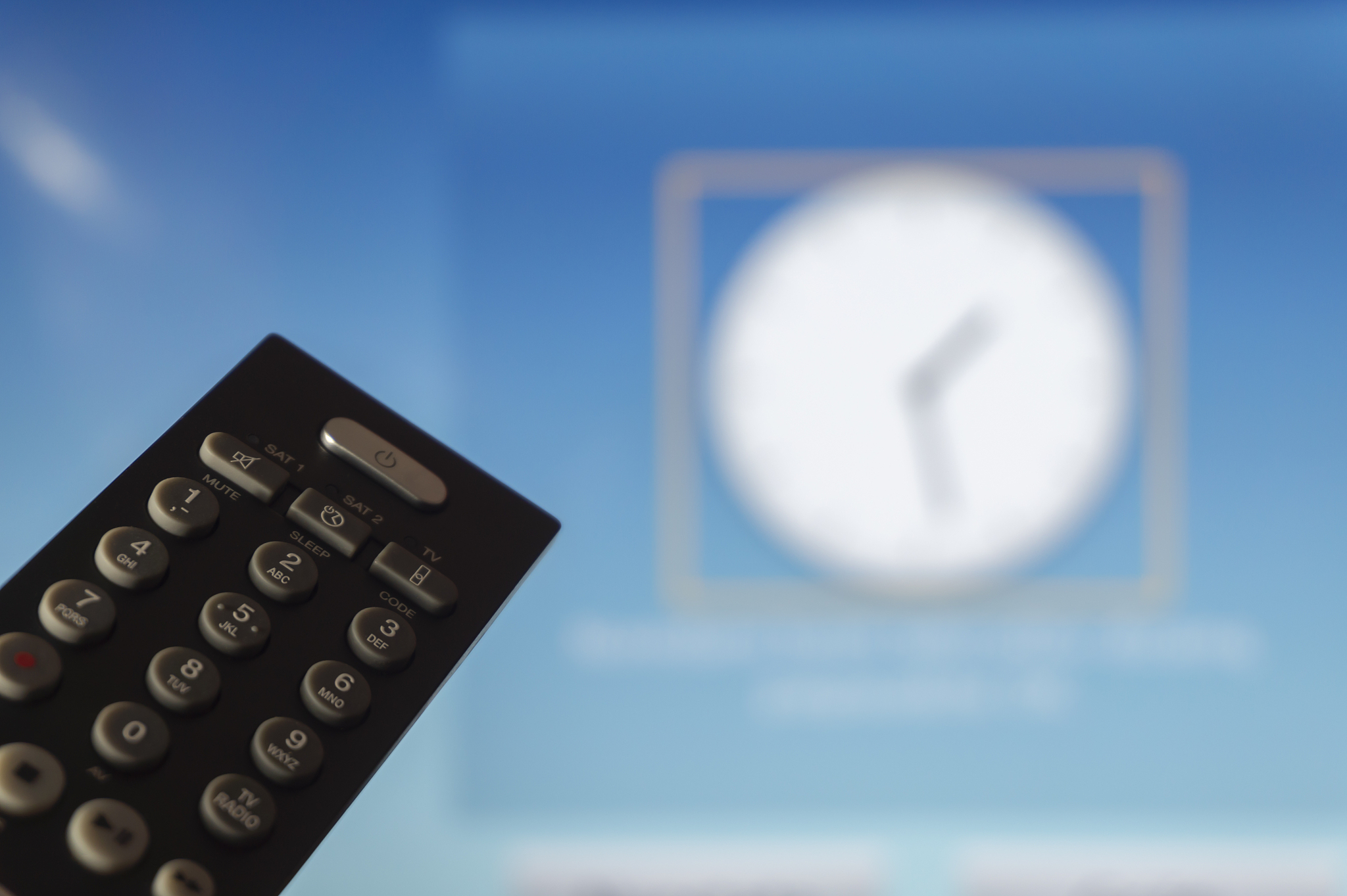 close-up of remote control and watching smart tv