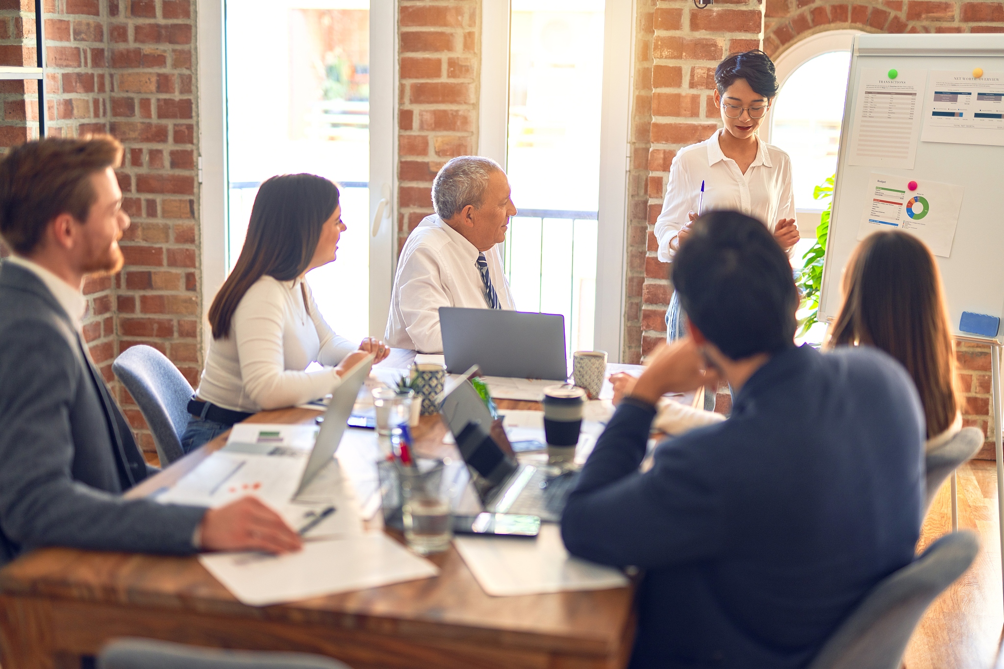 group of business workers working together in a meeting. one of 