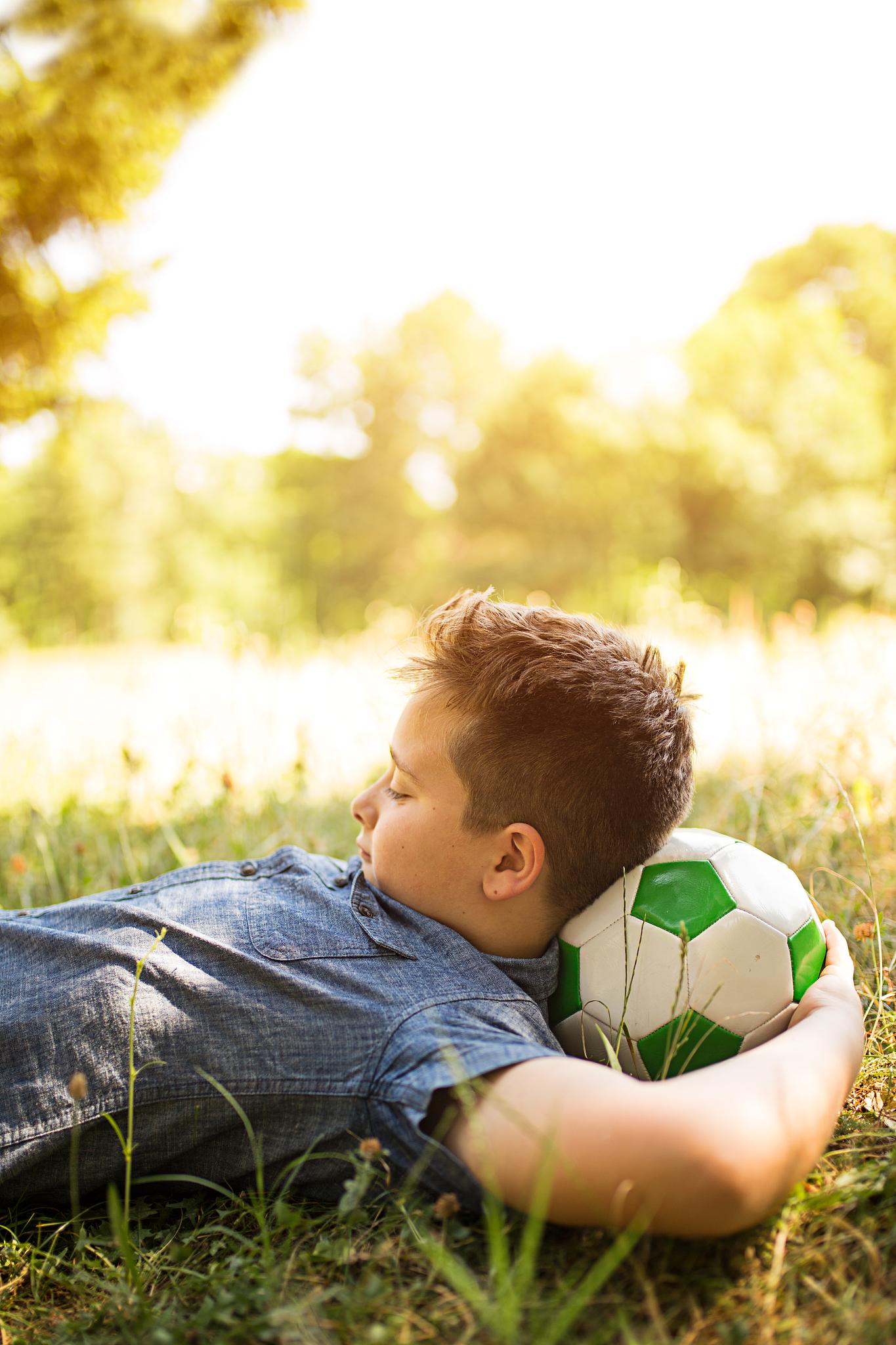 happy boy with headphones listening to music in park