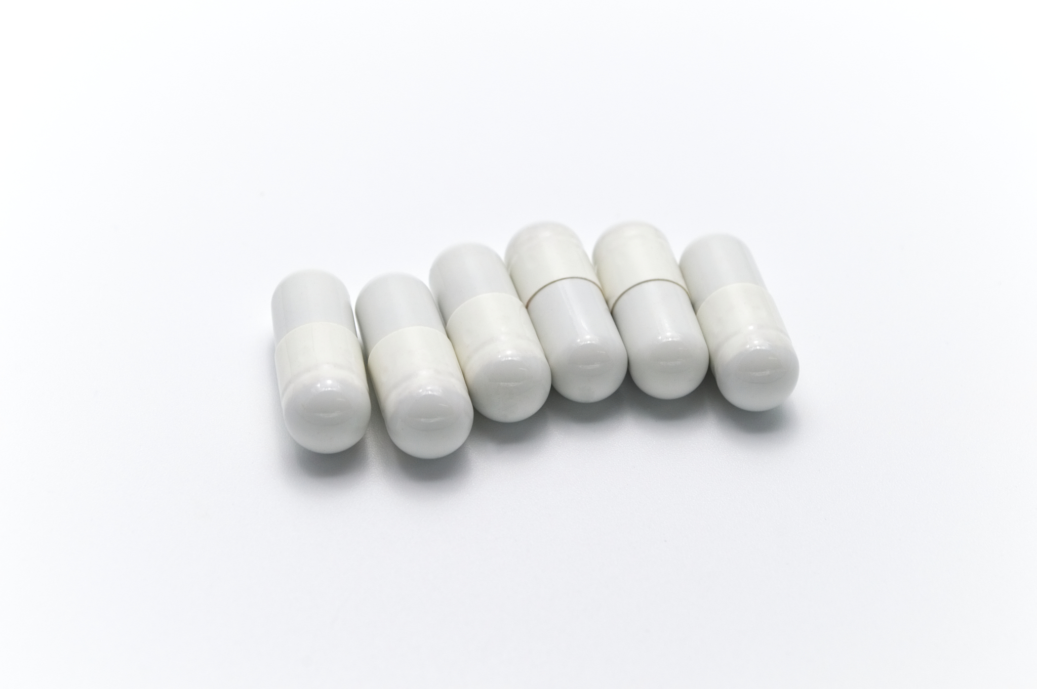 prescription drugs or medicine capsules of white color. on white