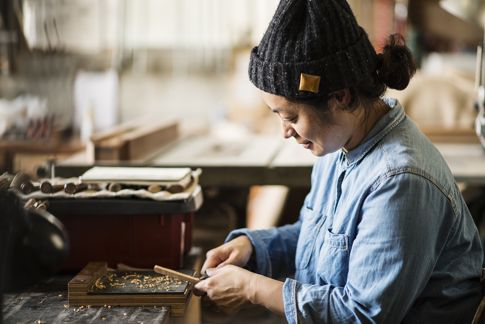 female craftsperson working in woodworking studio
