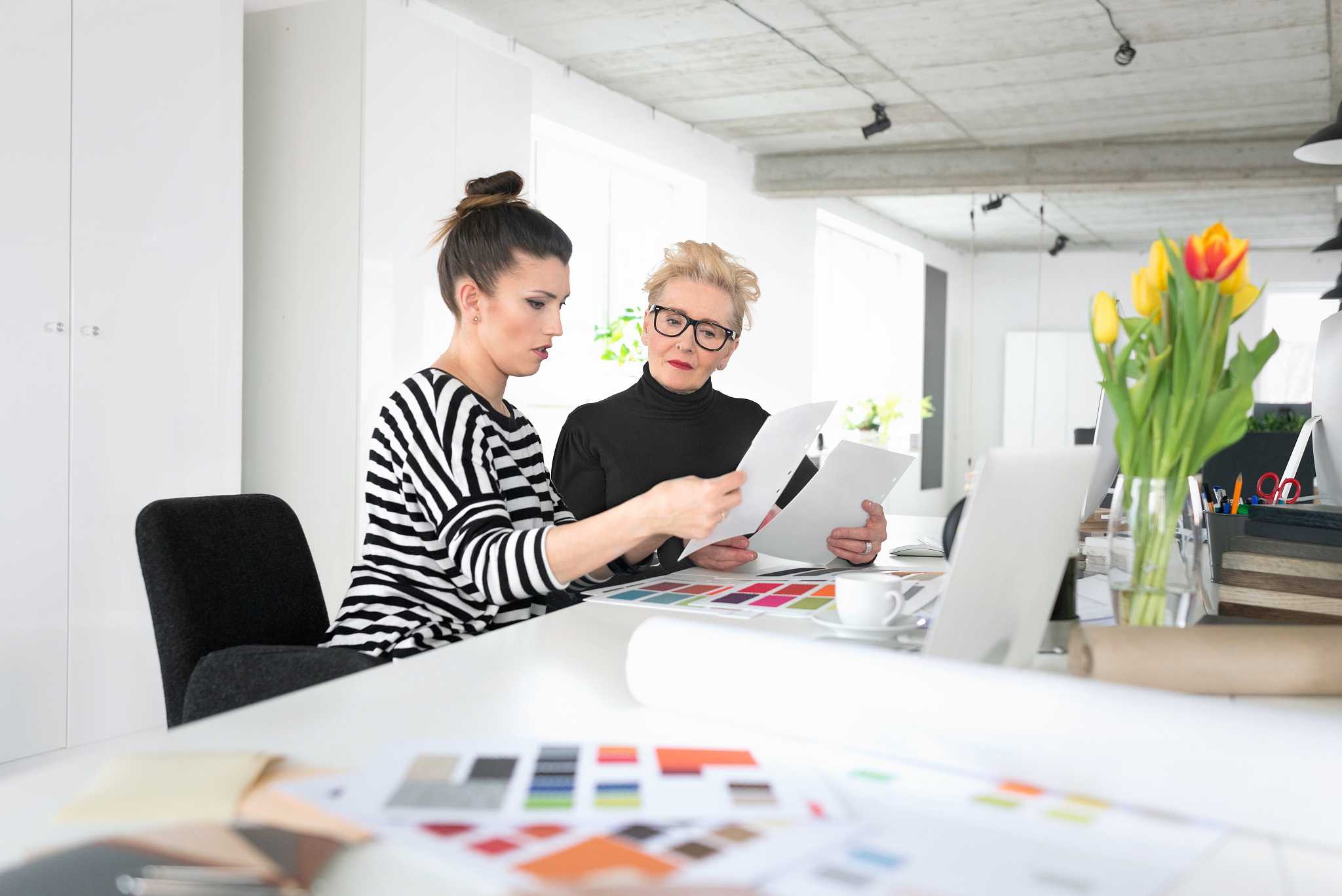 senior and young interior designers working together with young 