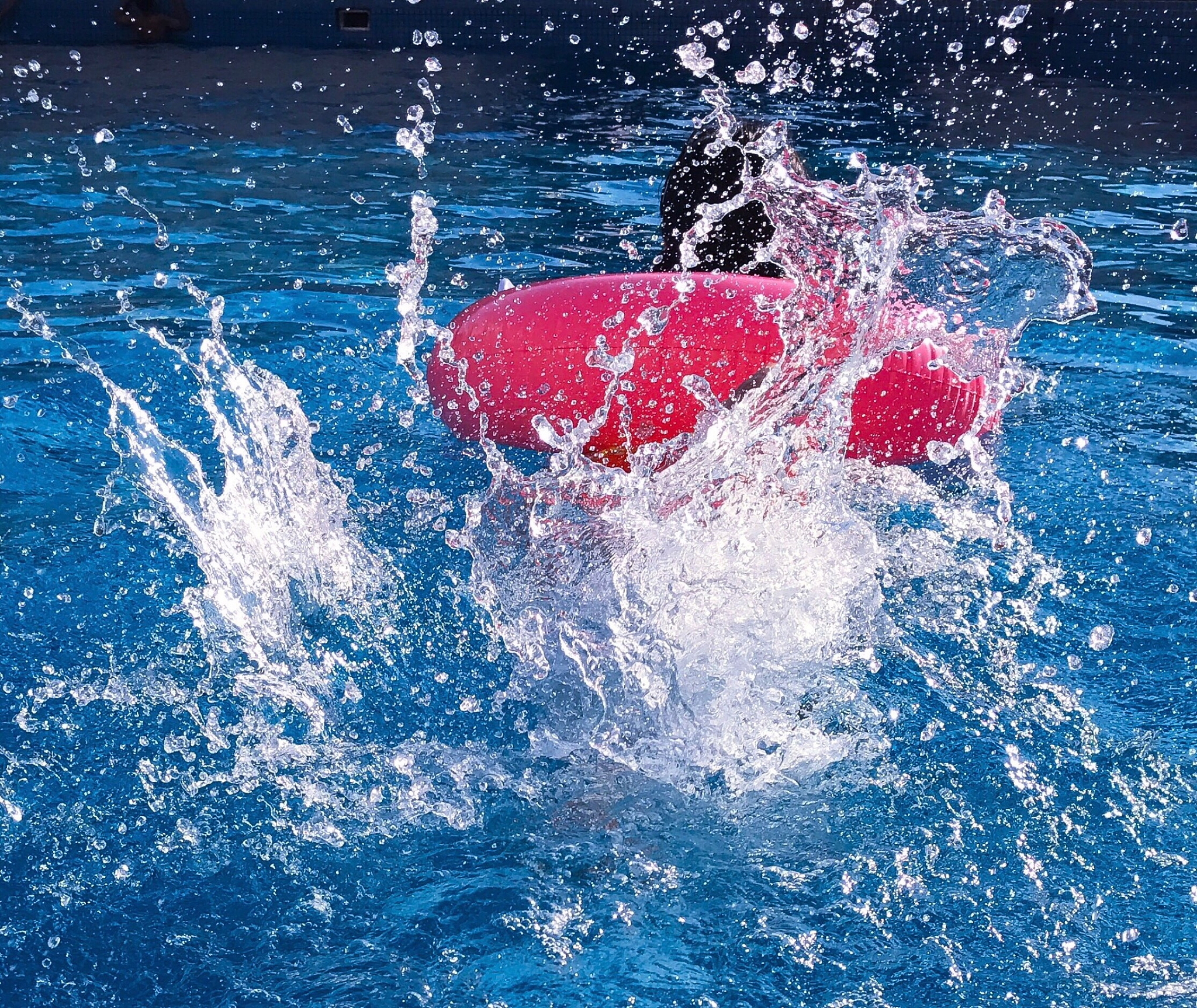 inflatable ring splashing water in swimming pool