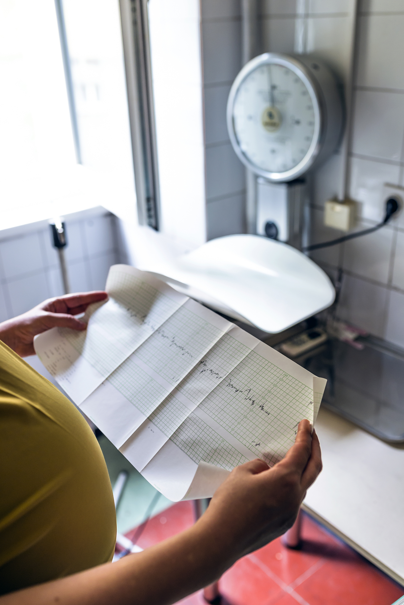 photo of woman holding contraction tracking document in the hosp
