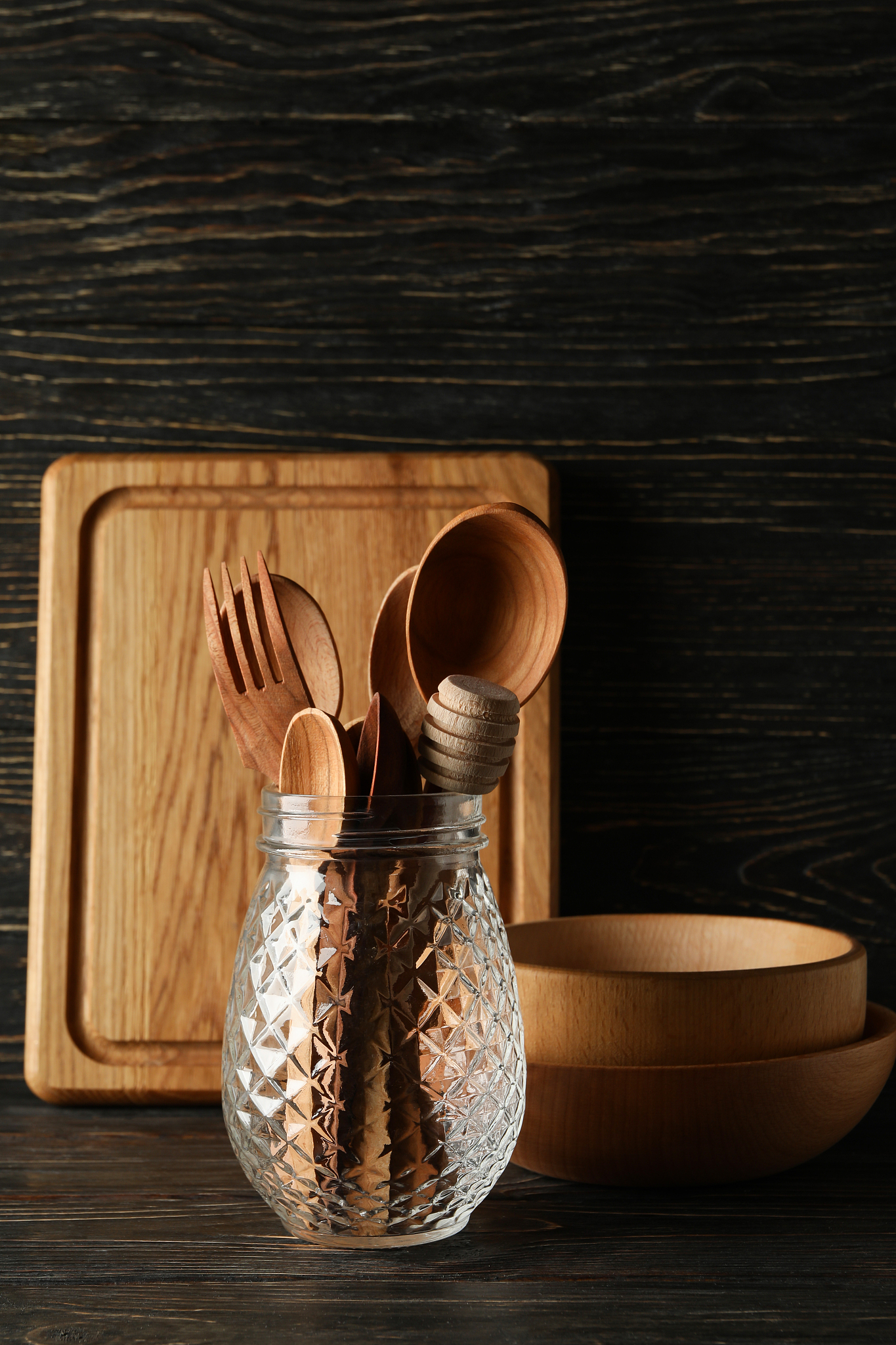 different wooden kitchenware on wooden background, space for tex