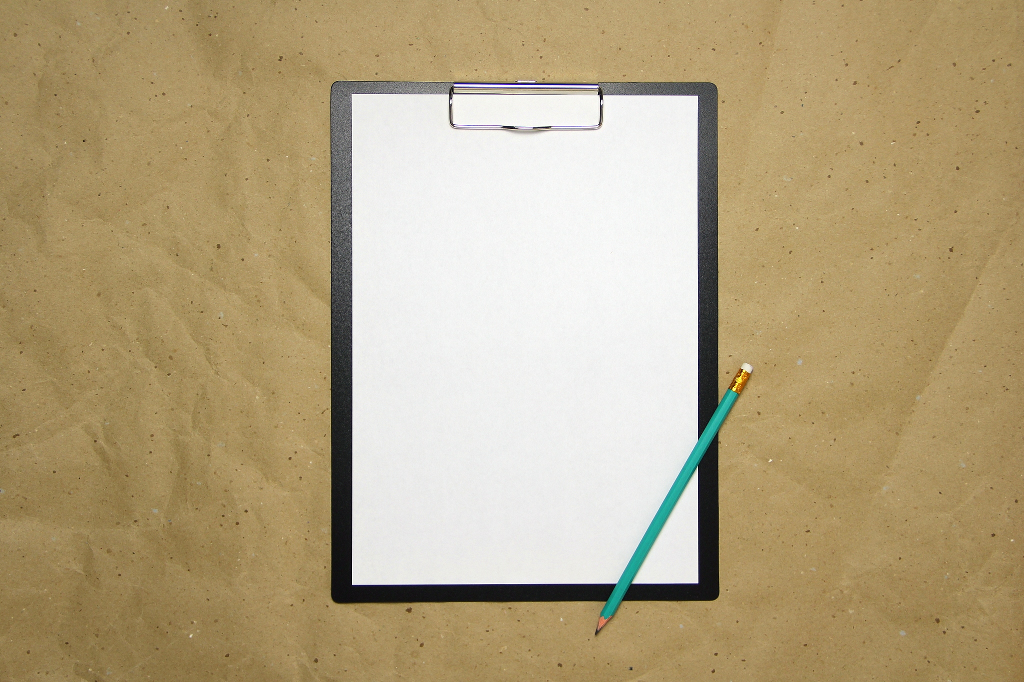 a tablet with a white sheet of a4 format on a beige craft paper
