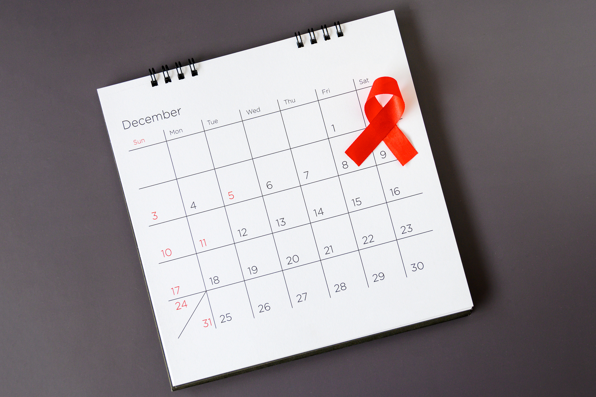 world aids day concept, red ribbon the date 1 december
