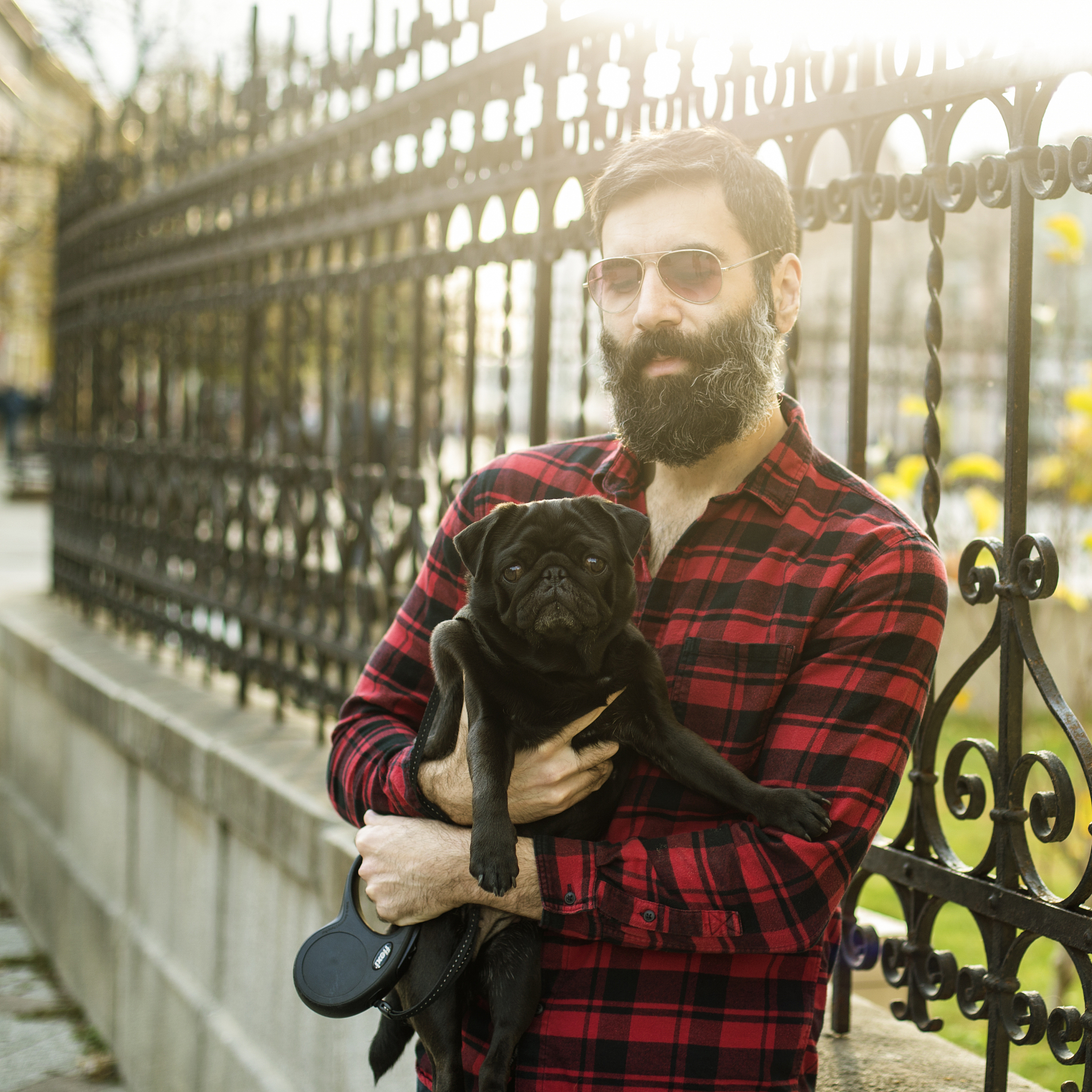 Handsome Man with Kitten in City - Captivating Portrait in White
