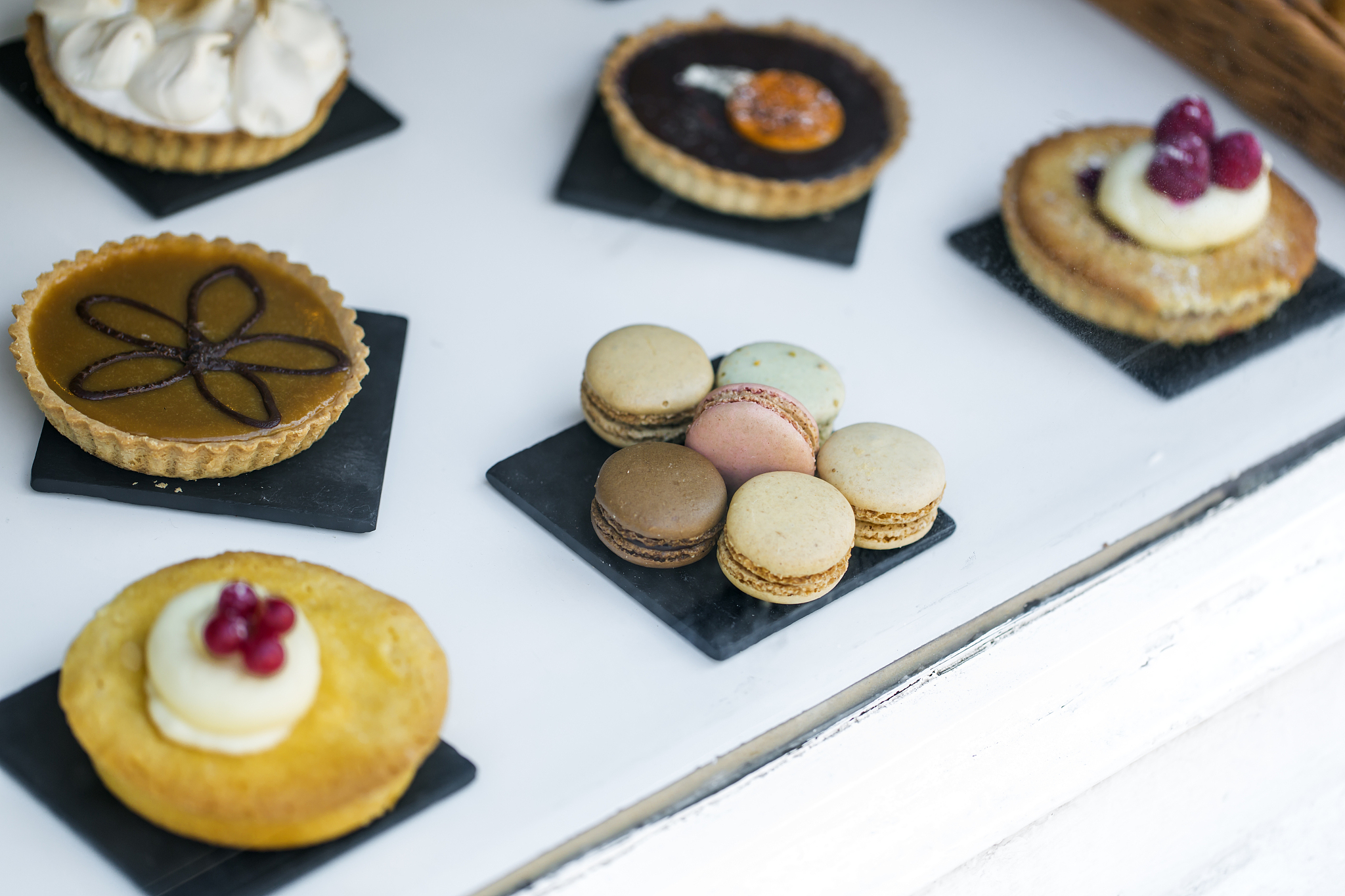 cakes and biscuits on display in a baker shop window