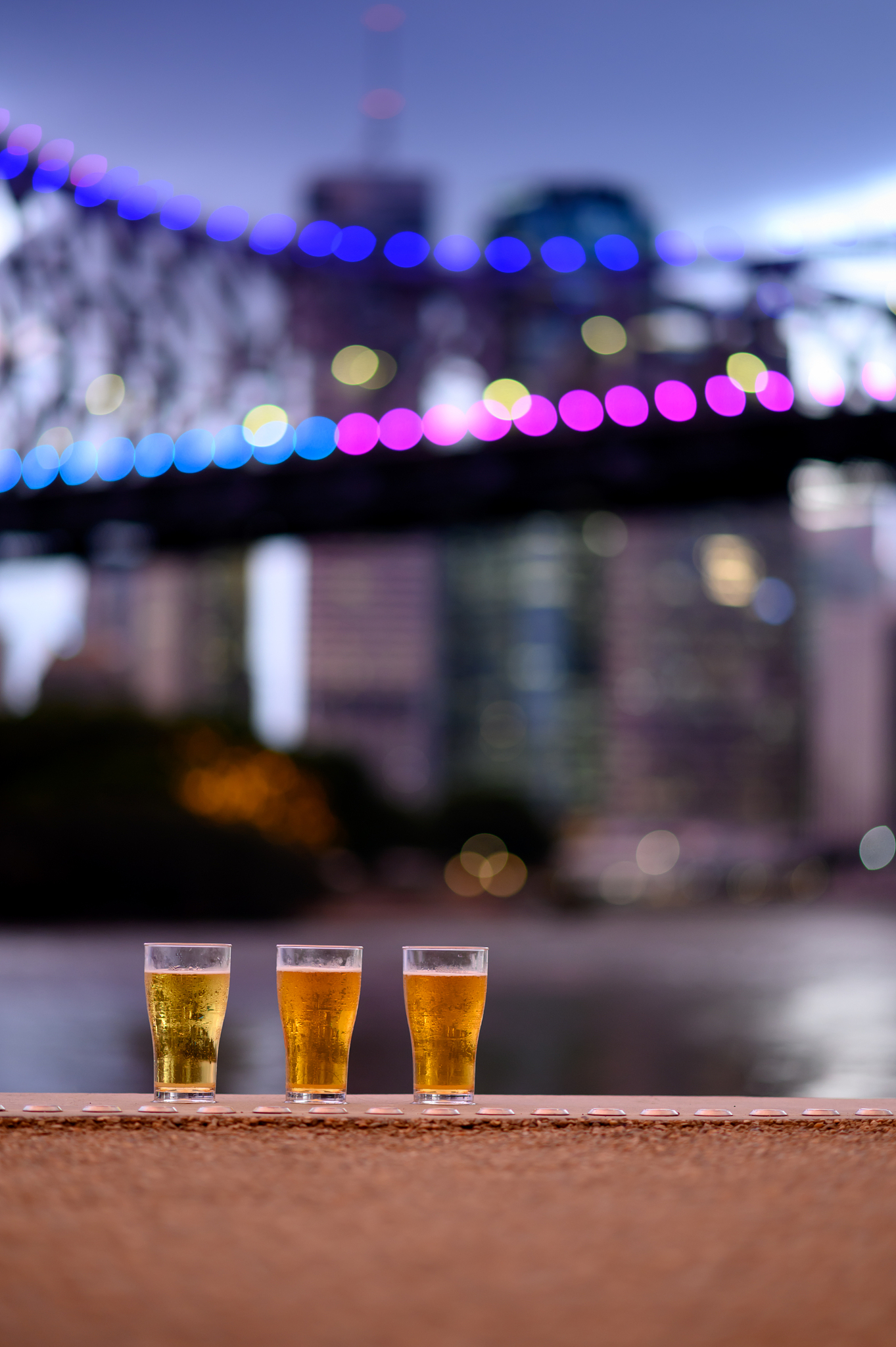three glass of beer and city background