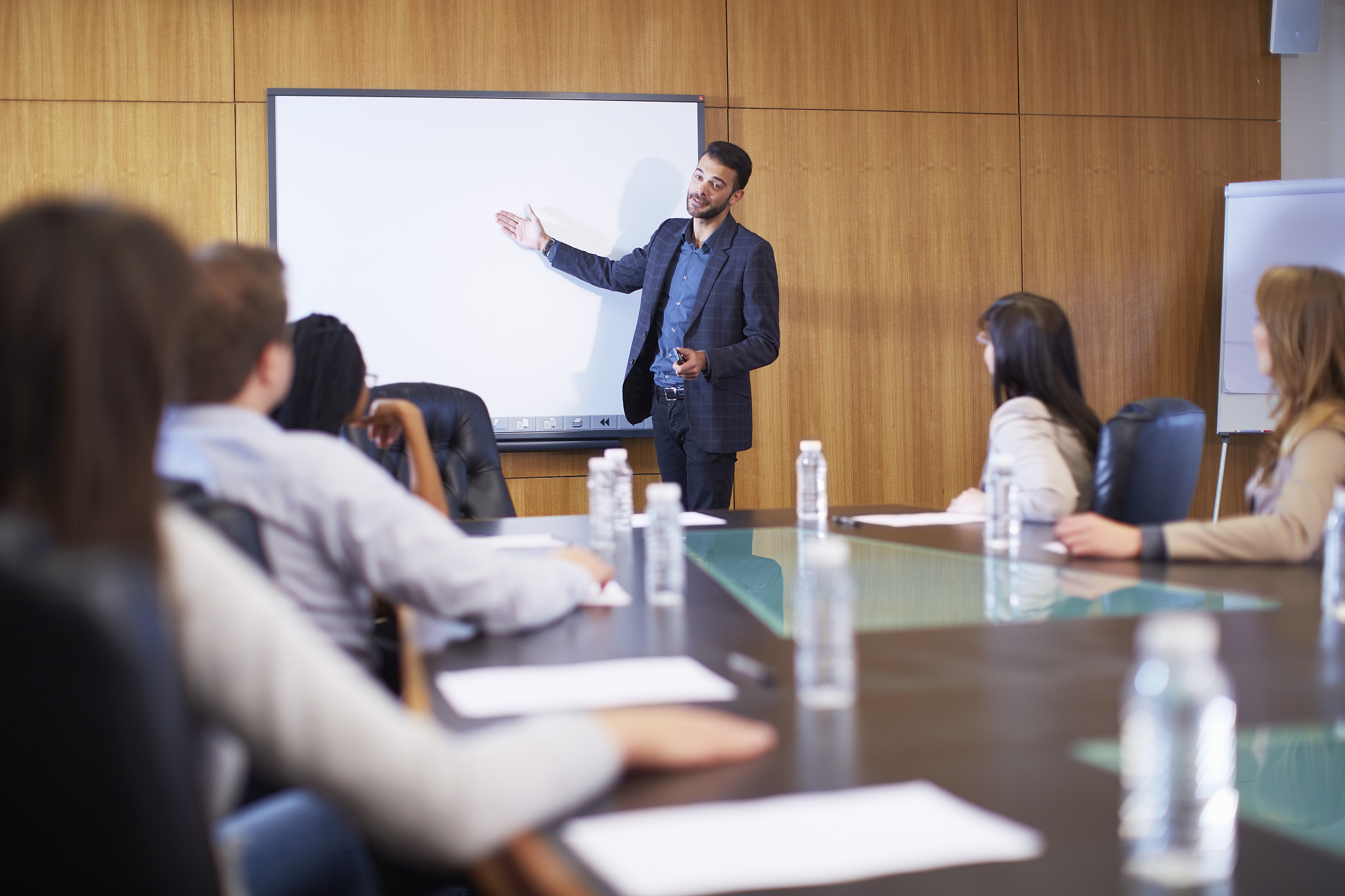 manager leading business meeting in boardroom