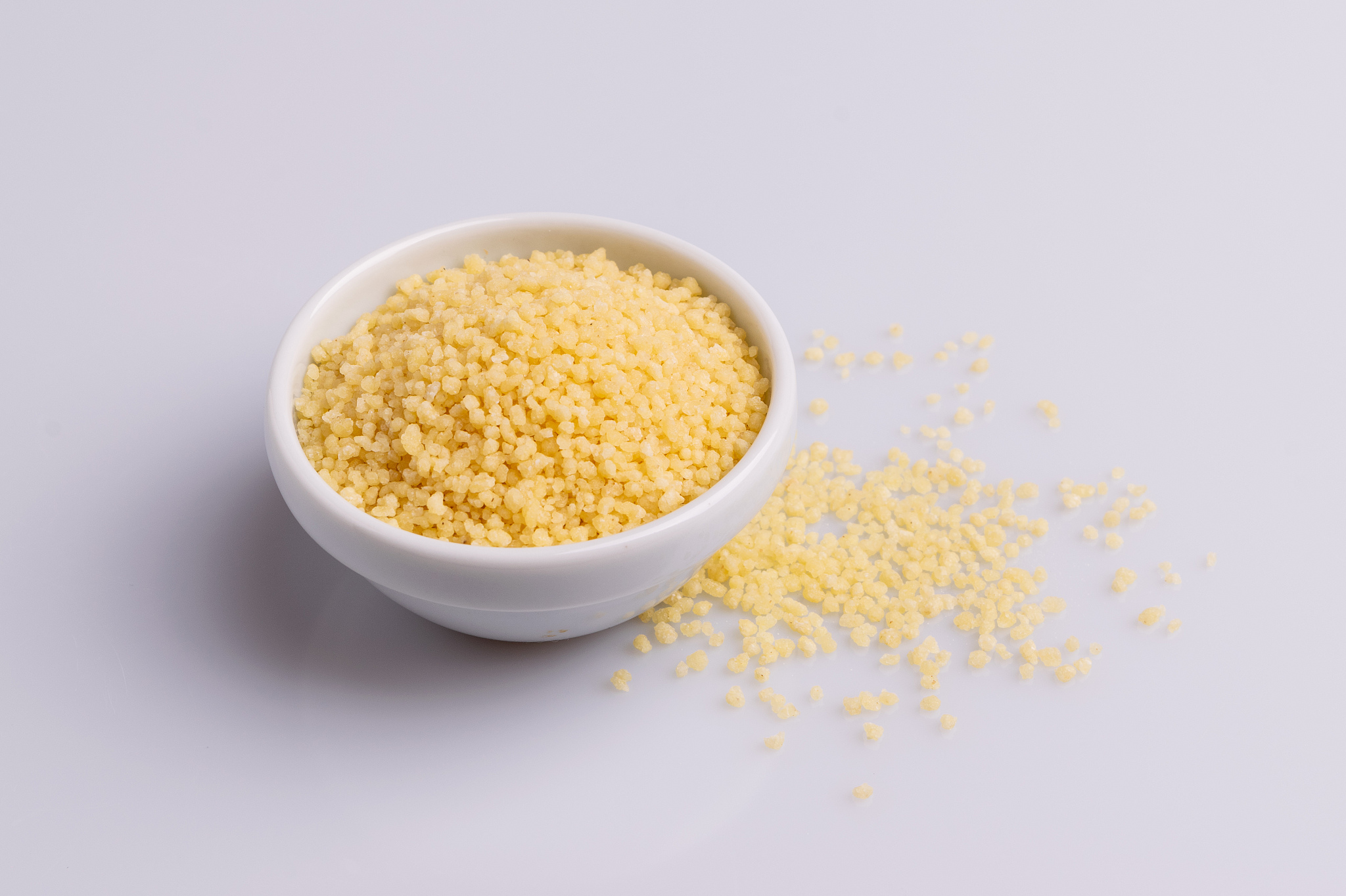 dry couscous isolated on white background, soft light, copy spac