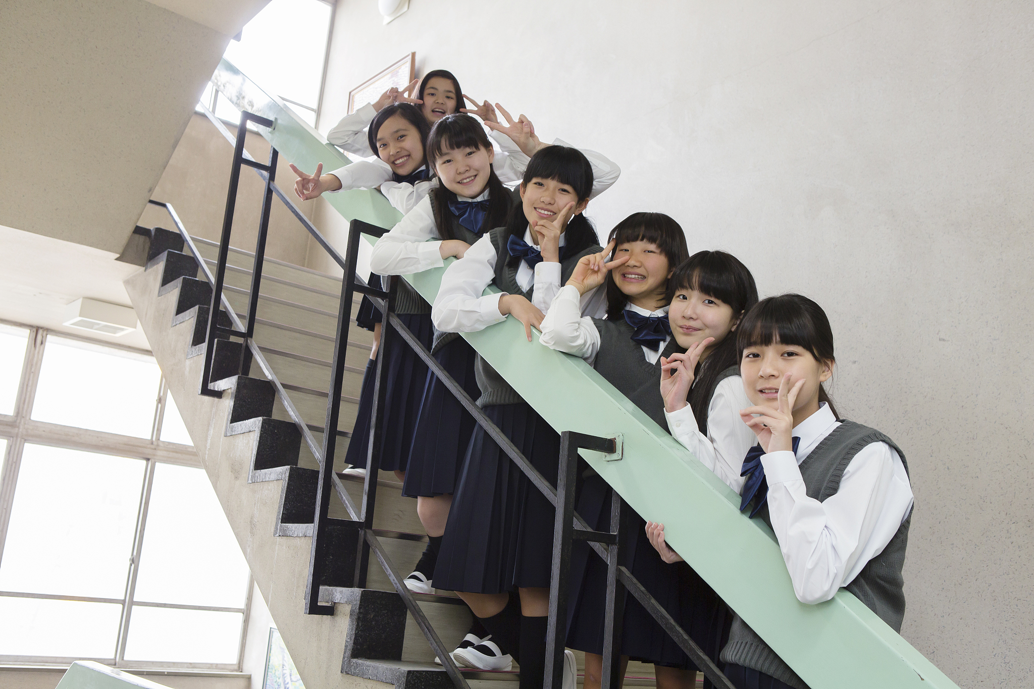 students of japanese lined up in the stairs