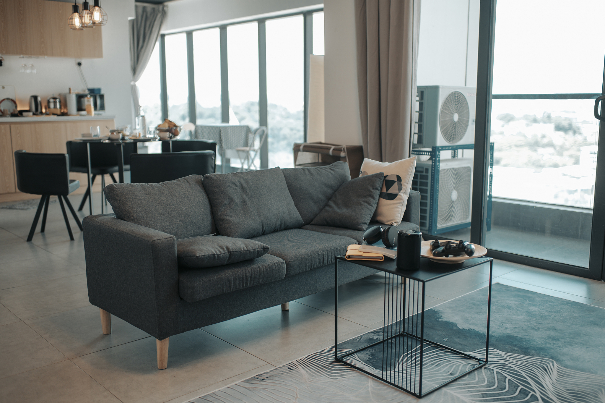 living room and kitchen of apartment with sofa and coffee table