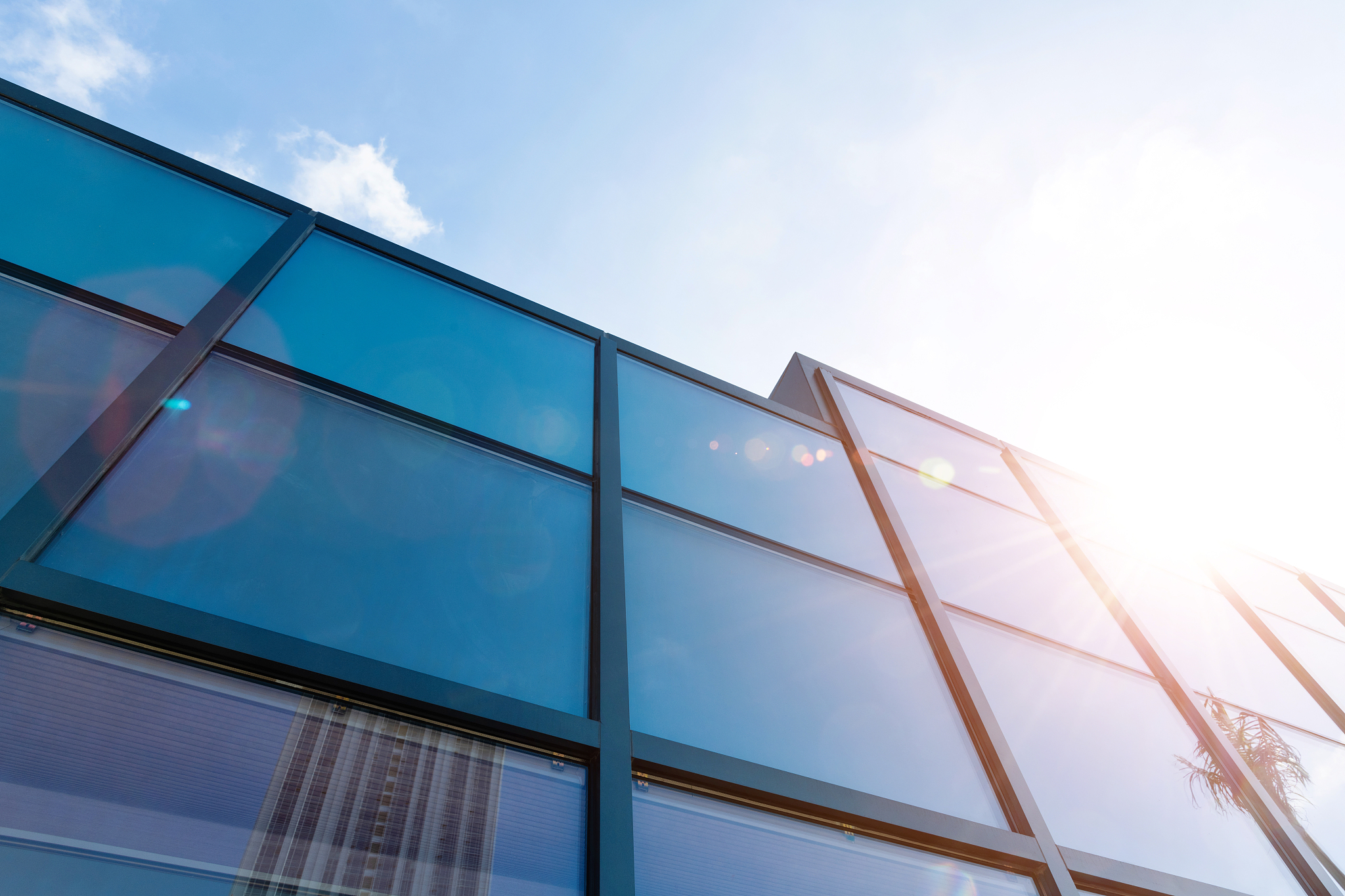 cloud sky reflected on glass windows of modern building