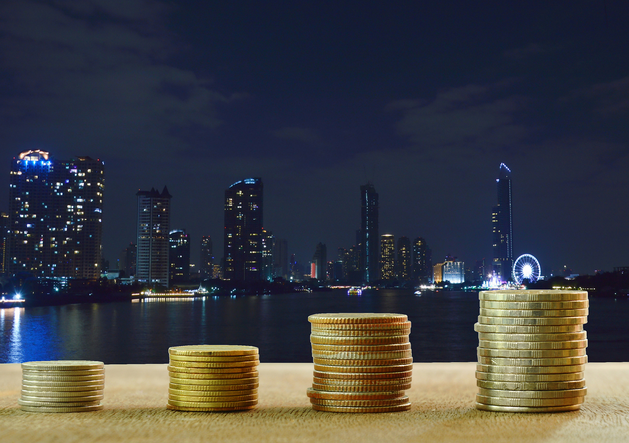 coin on wooden board with night city view background