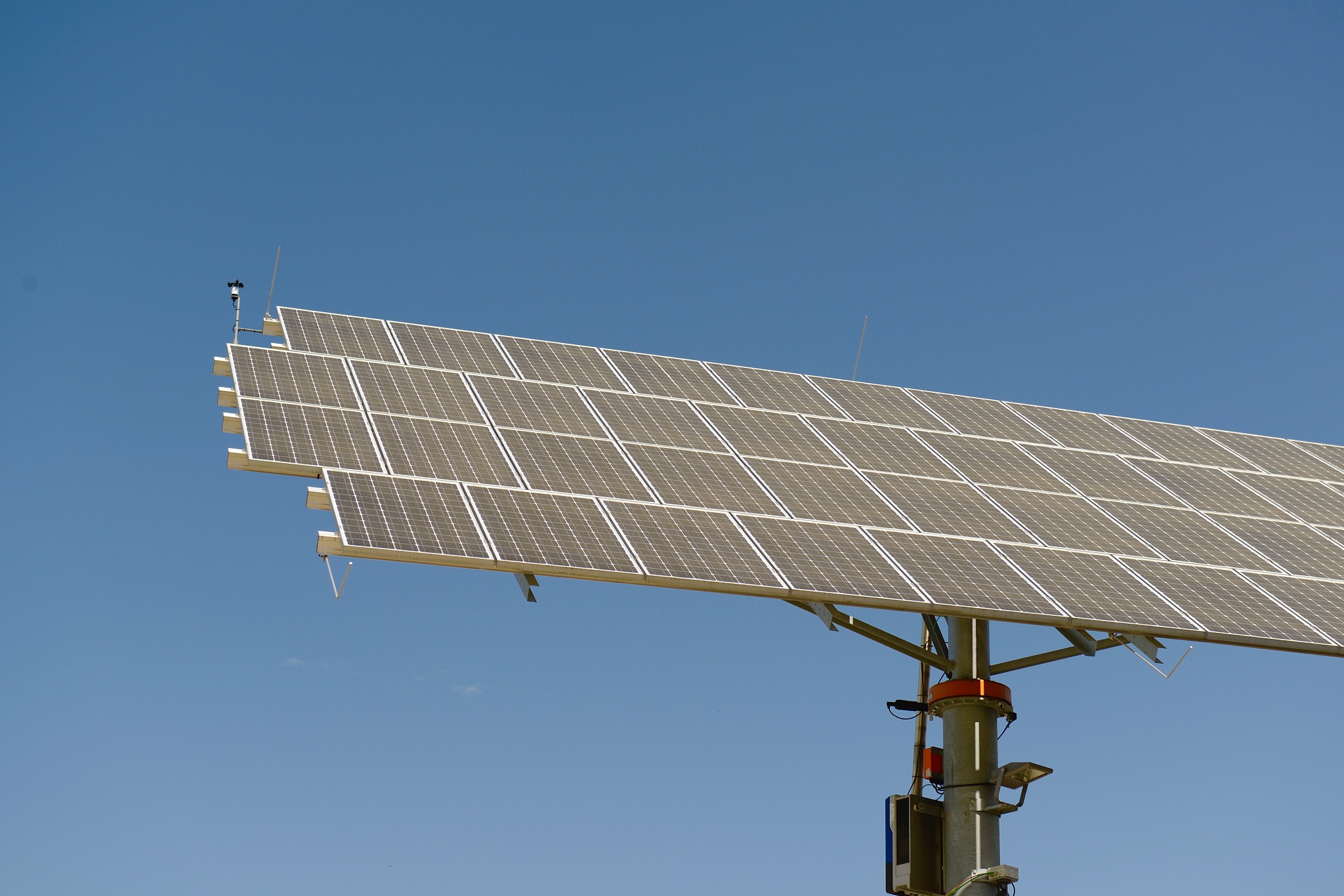 low angle view of solar panels against clear blue sky