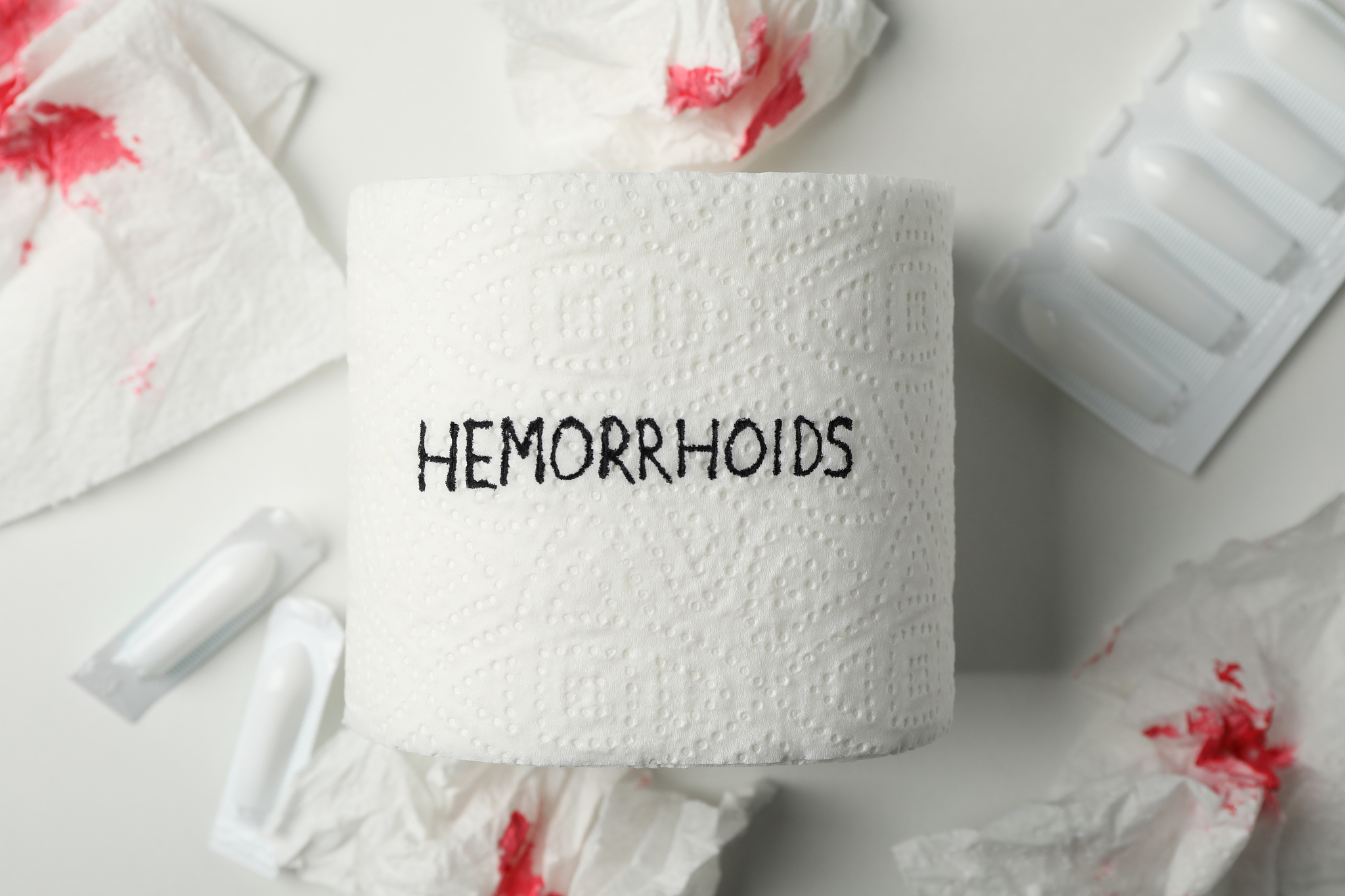 toilet paper with hemorrhoids, candles and paper with blood on w