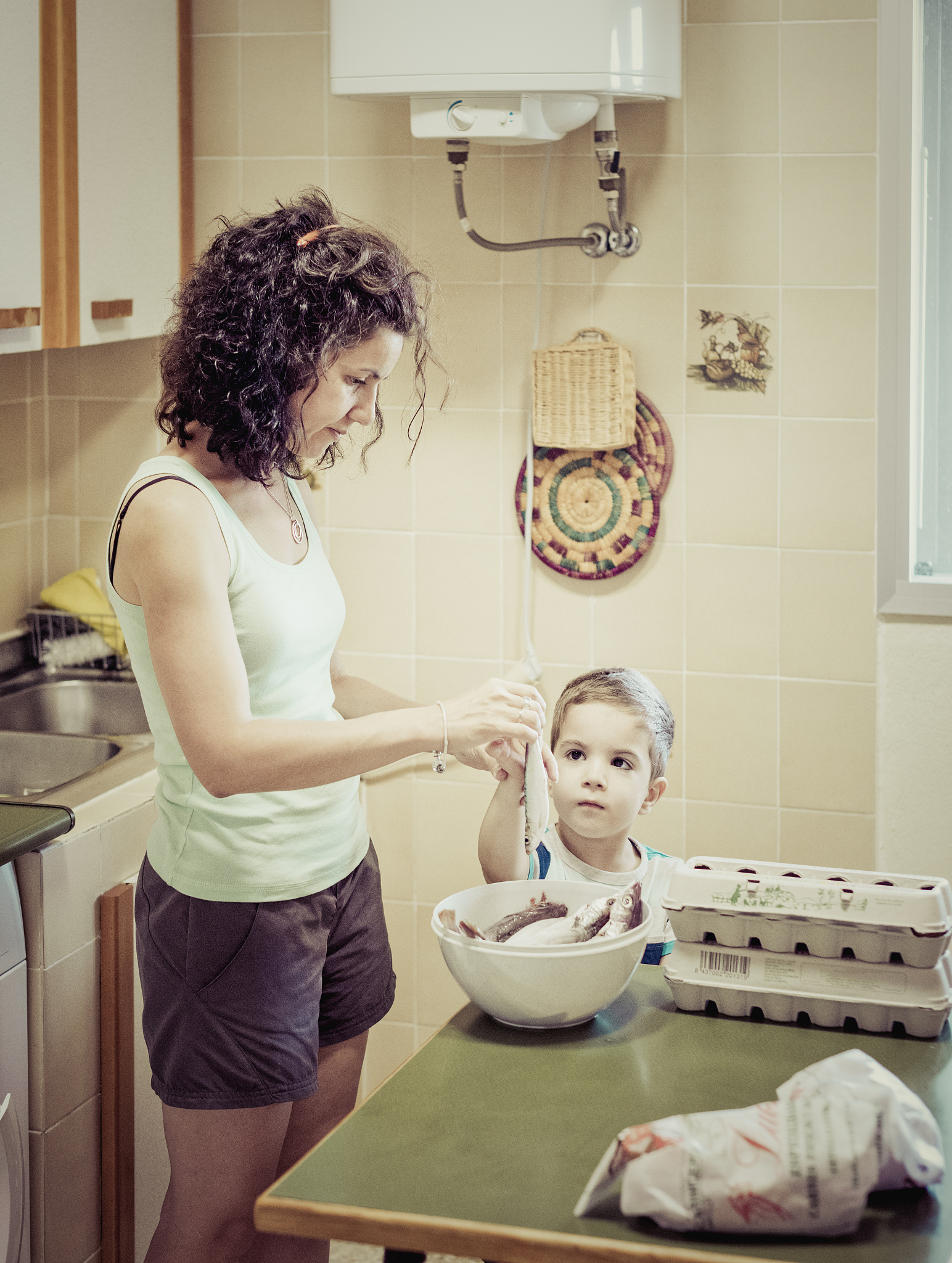 woman cooking fish in the kitchen